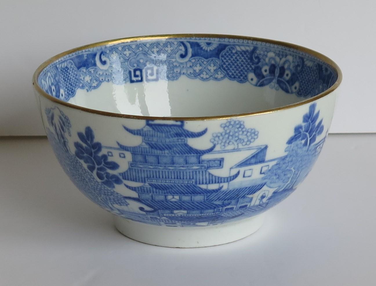 This is a porcelain bowl made by Miles Mason (Mason's), Staffordshire Potteries, England around the turn of the 18th century, circa 1805. 

The bowl is well potted on a low foot.

It is decorated in the under-glaze blue printed Pagoda or
