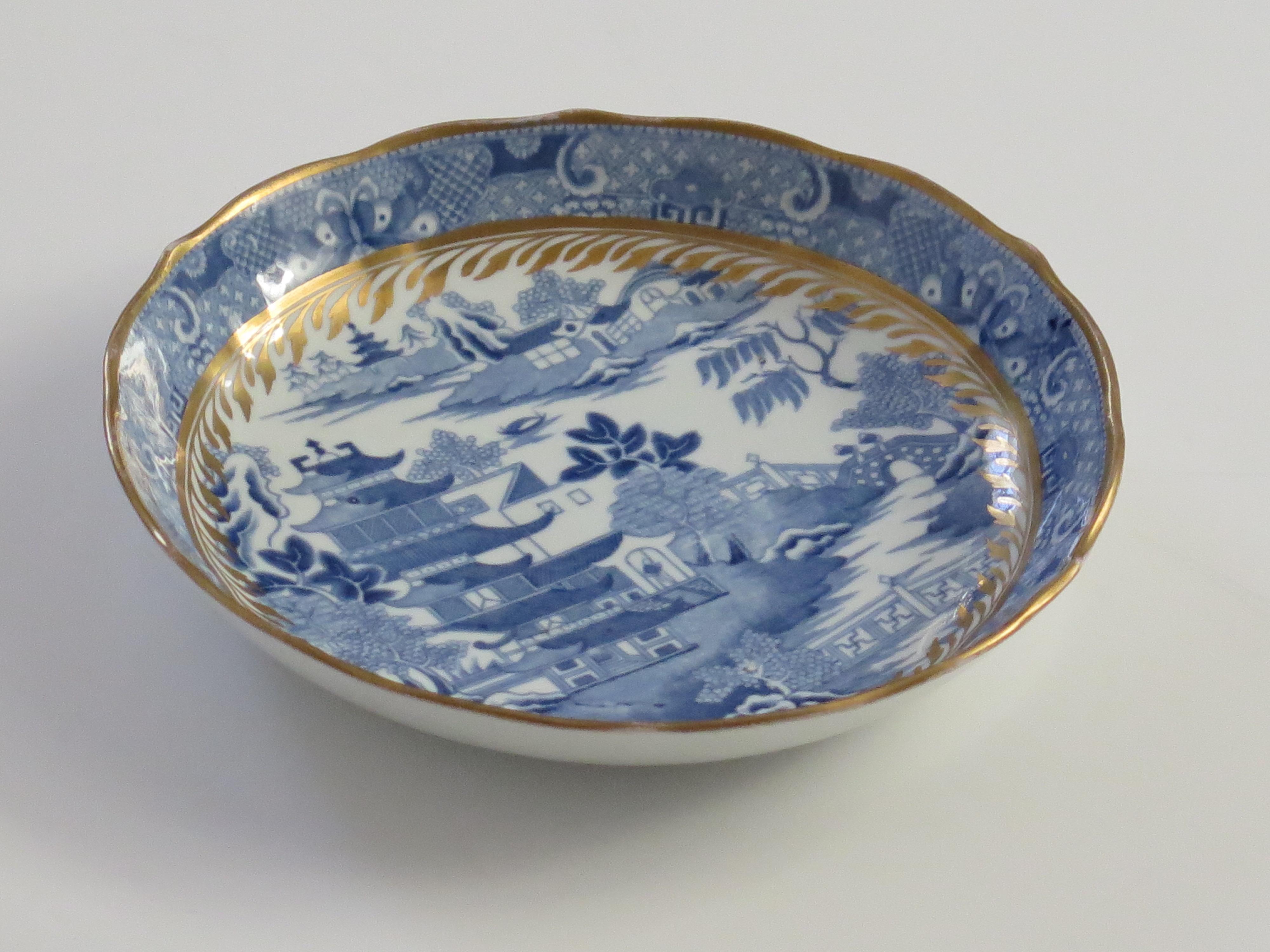This is a Porcelain blue and white, hand gilded Saucer Dish / Bowl made by Miles Mason (Mason's), Staffordshire Potteries, England around the turn of the 18th century, circa 1805. 

The dish is well potted on a low foot with slightly fluted sides