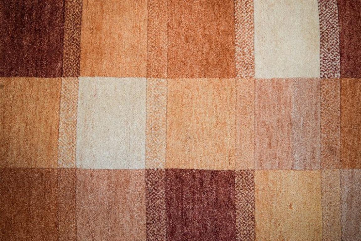 Milford, Sweden, pure wool rug. Geometric fields in red, orange and white shades. 
1970s.
Measuring: 200 x 80 cm.
In excellent condition.
A label on the back.