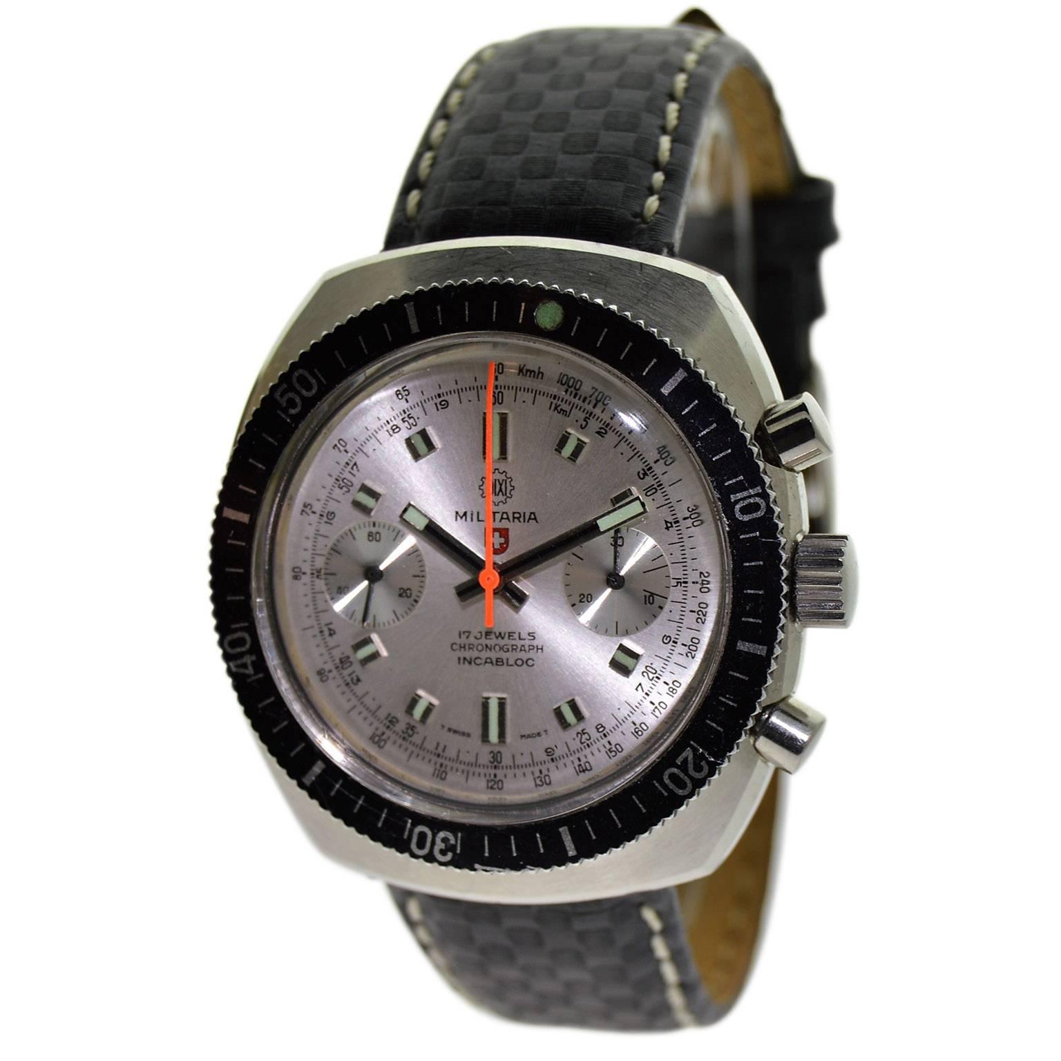 FACTORY / HOUSE: Militaria Watch Company
STYLE / REFERENCE: Cushion Shaped / Chronograph
METAL / MATERIAL:  Stainless Steel 
CIRCA: 1970's
DIMENSIONS: Length 43mm X Width 39mm
MOVEMENT / CALIBER: Manual Winding / 17 Jewels / Incabloc Cal. Valjoux