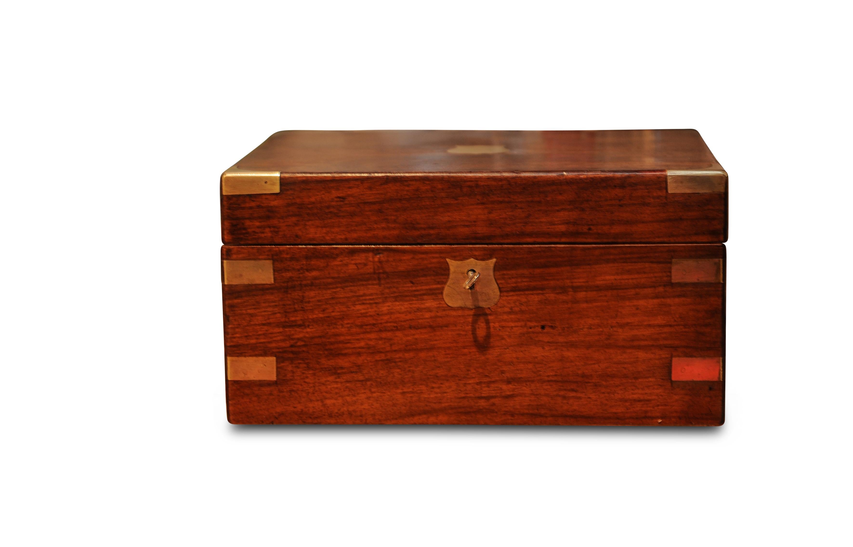 A military campaign brass bound walnut veneered writing slope, with a vintage pen.
Opening up to reveal the classic fitted interior with black felt inlay.
With one glass ink pot with brass lid.
Key included for the main lock.
Wonderful patina to