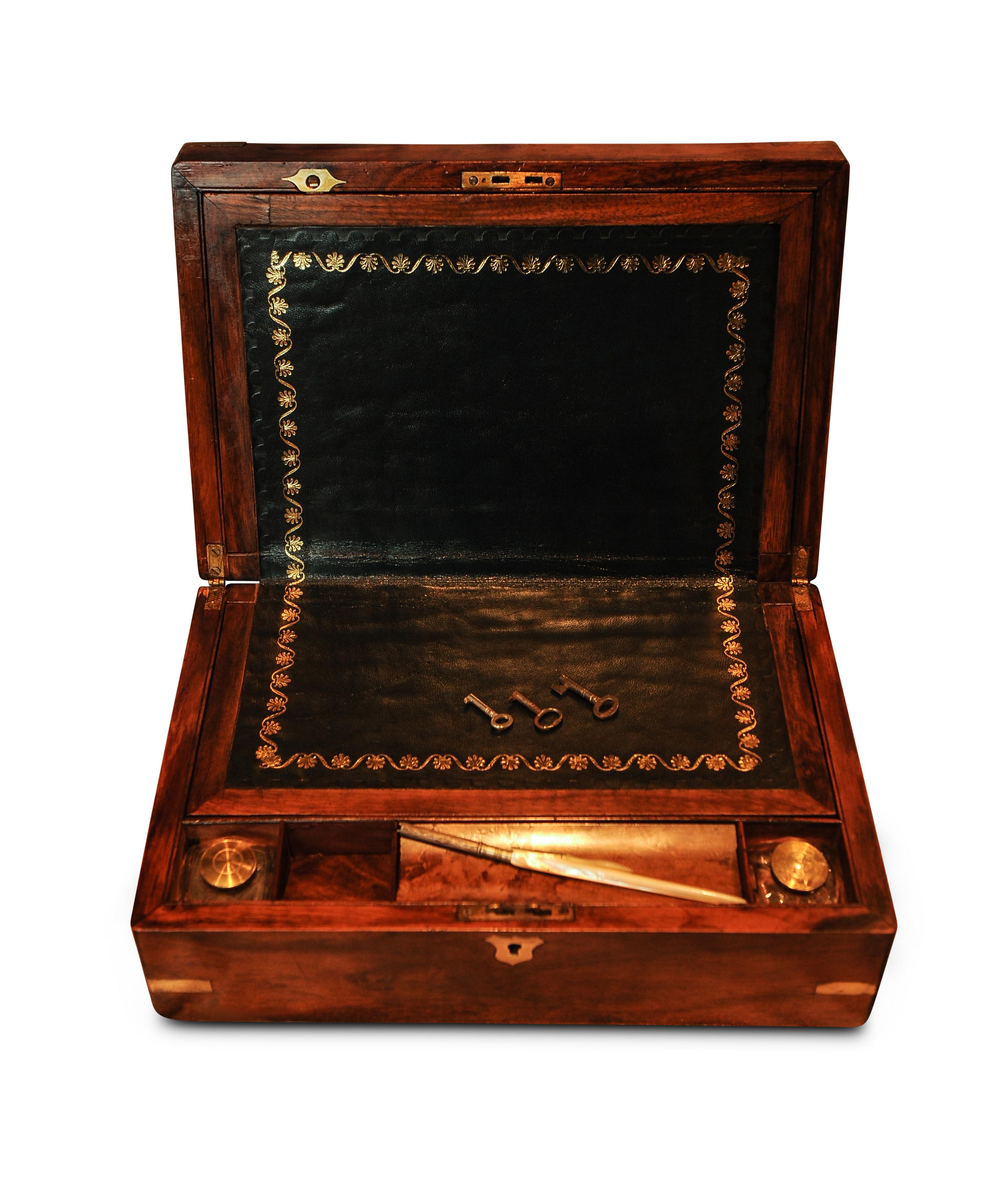 A military campaign brass bound walnut veneered writing slope,
opening to reveal the usual fitted interior with embossed black leather top.
2 glass ink pots in separate compartments with brass lids.
1 mother of pearl writing pen holder and mother
