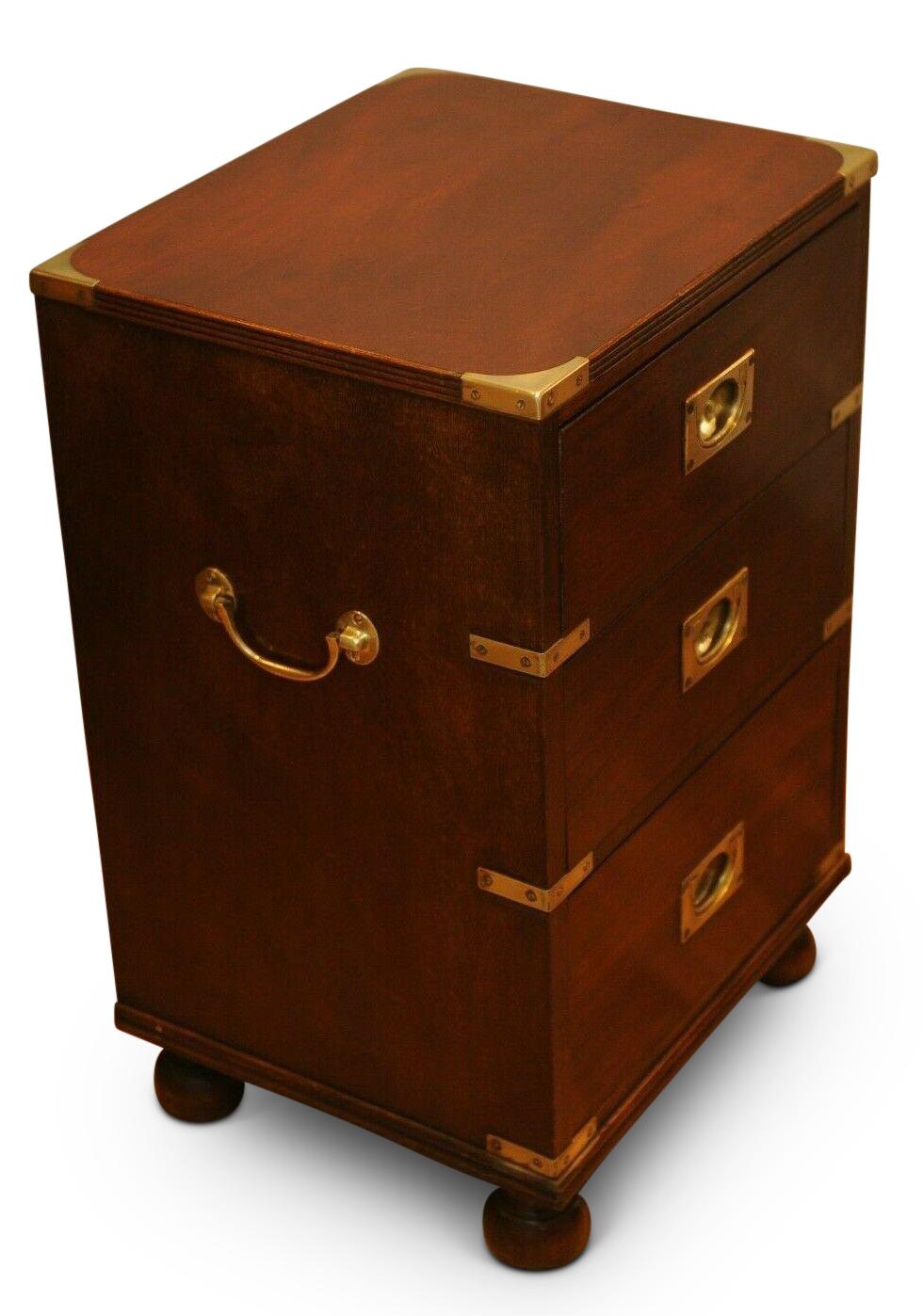 Military Campaign chest brass bound mahogany three drawer pedestal, side table on bun feet with brass side handles.
  