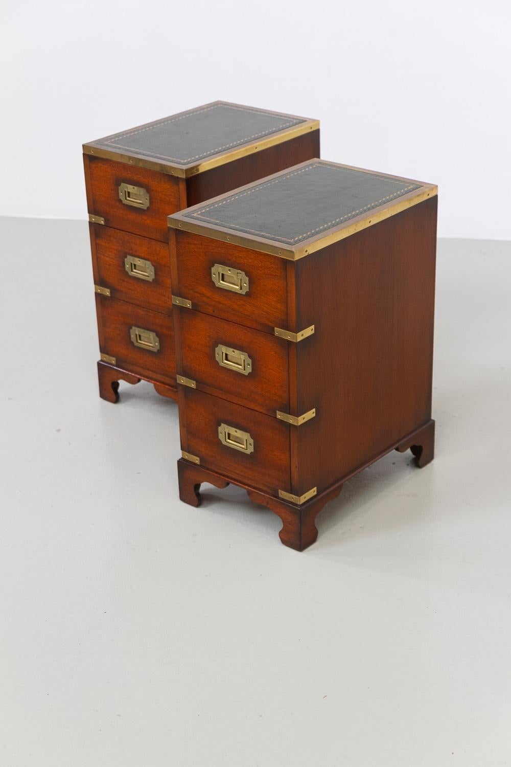 Military Campaign Style Bedside Chests, 1950s. Set of 2. 

A great pair of military campaign style three drawer night stands. Made in England in solid mahogany with brass fittings and embossed green leather tops.

Very sturdy quality pieces with