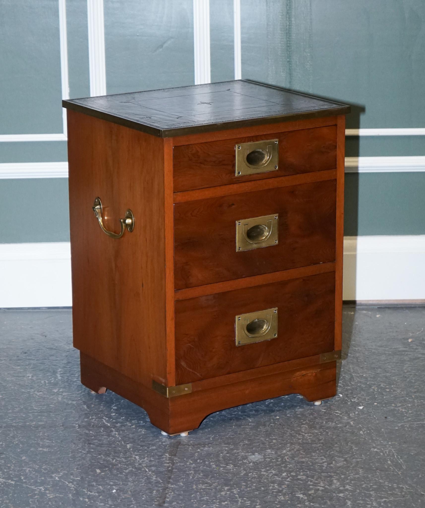 We are excited to offer for sale this military campaign bedside nightstand end table.

It has brass fittings and traditional brass handles.
The top is inlaid with the original green leather which has some patina on it.
It serves three drawers