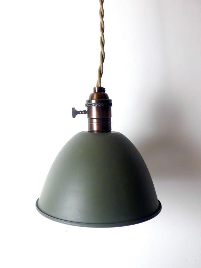 Military field swinging lamps, gray enameled metal shades with brass sockets.
Original shape and patina. Eight pieces available. The lamps have been rewired and are priced and sold separately. The price is intended for each lamp.