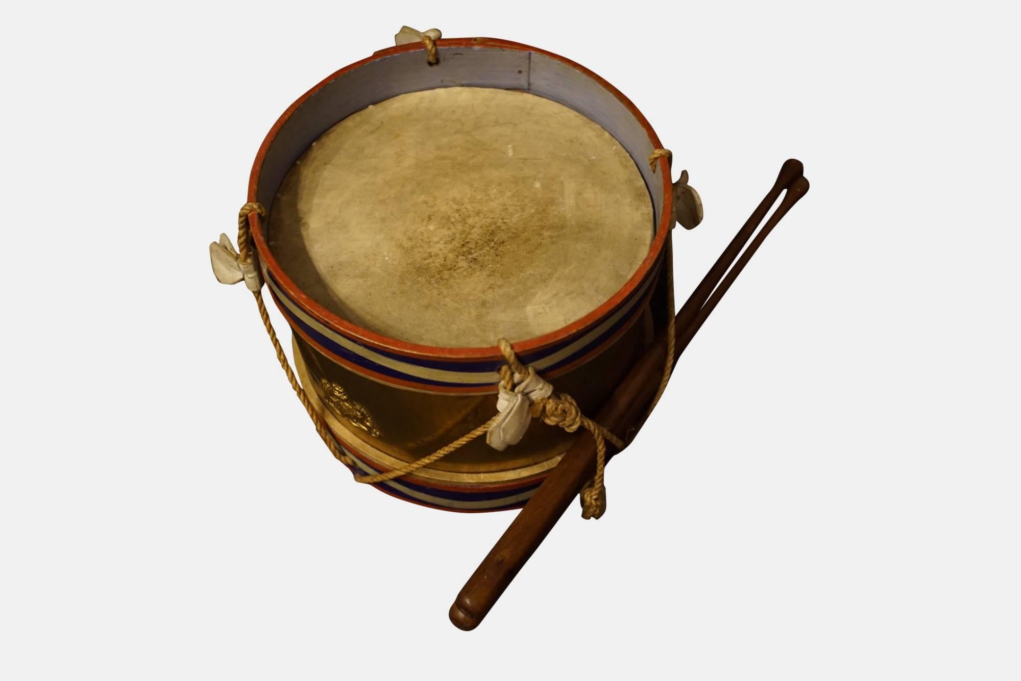 A military style drum for a child with pair of drumsticks,

circa 1910.