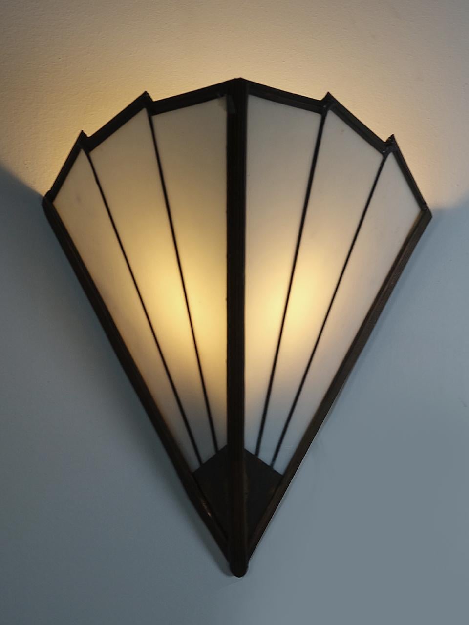 These very deco looking sconces are handmade using milk glass and brass. It's a 2 sided fan design... simple and tasteful.
We have a few of these 6 panel sconces in stock. They are prices per lamp so you can buy one or the collection.