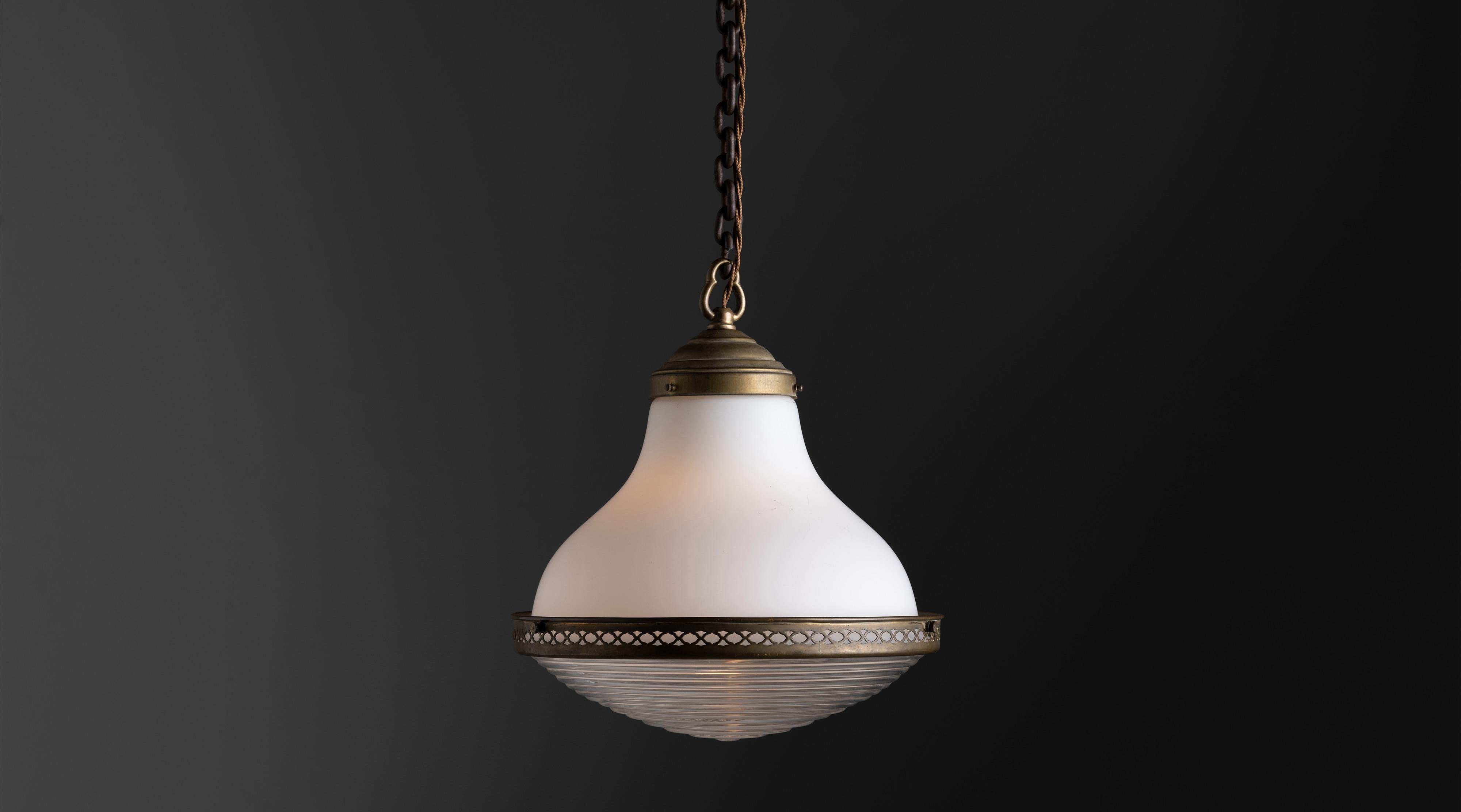 German two tone pendant, Germany Circa 1930

Milk glass upper, with ribbed glass lower and perforated brass brace.

 