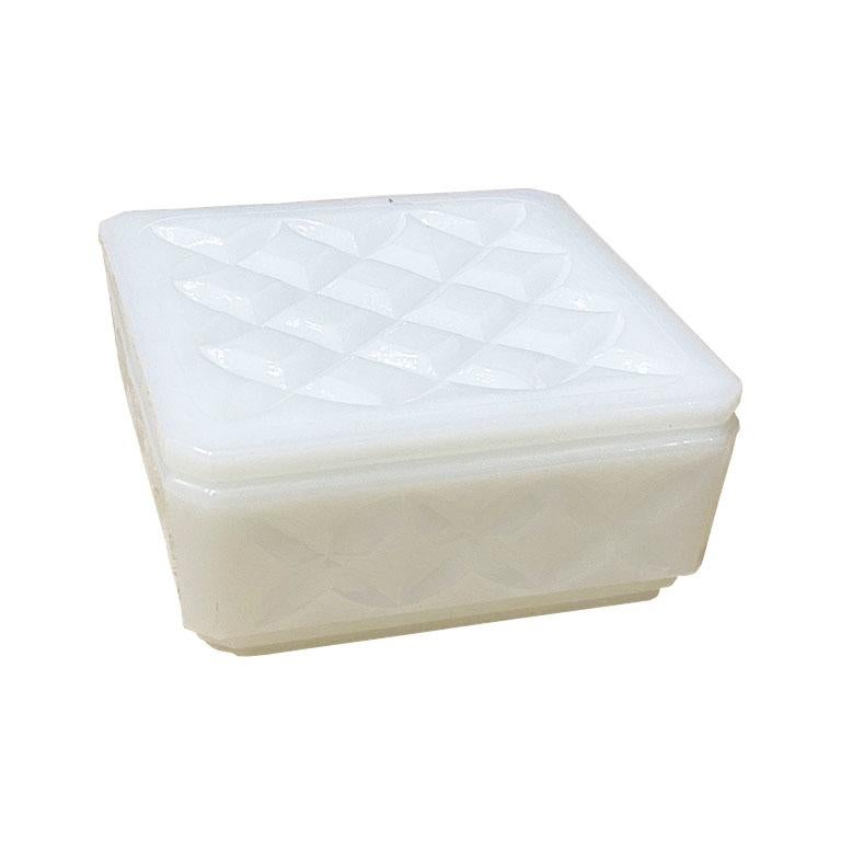 A beautiful cut milk glass trinket box, or jewelry box. This lovely piece is square in shape, with diamond shape decoration on both the lid and sides. 

Dimensions:
4.25