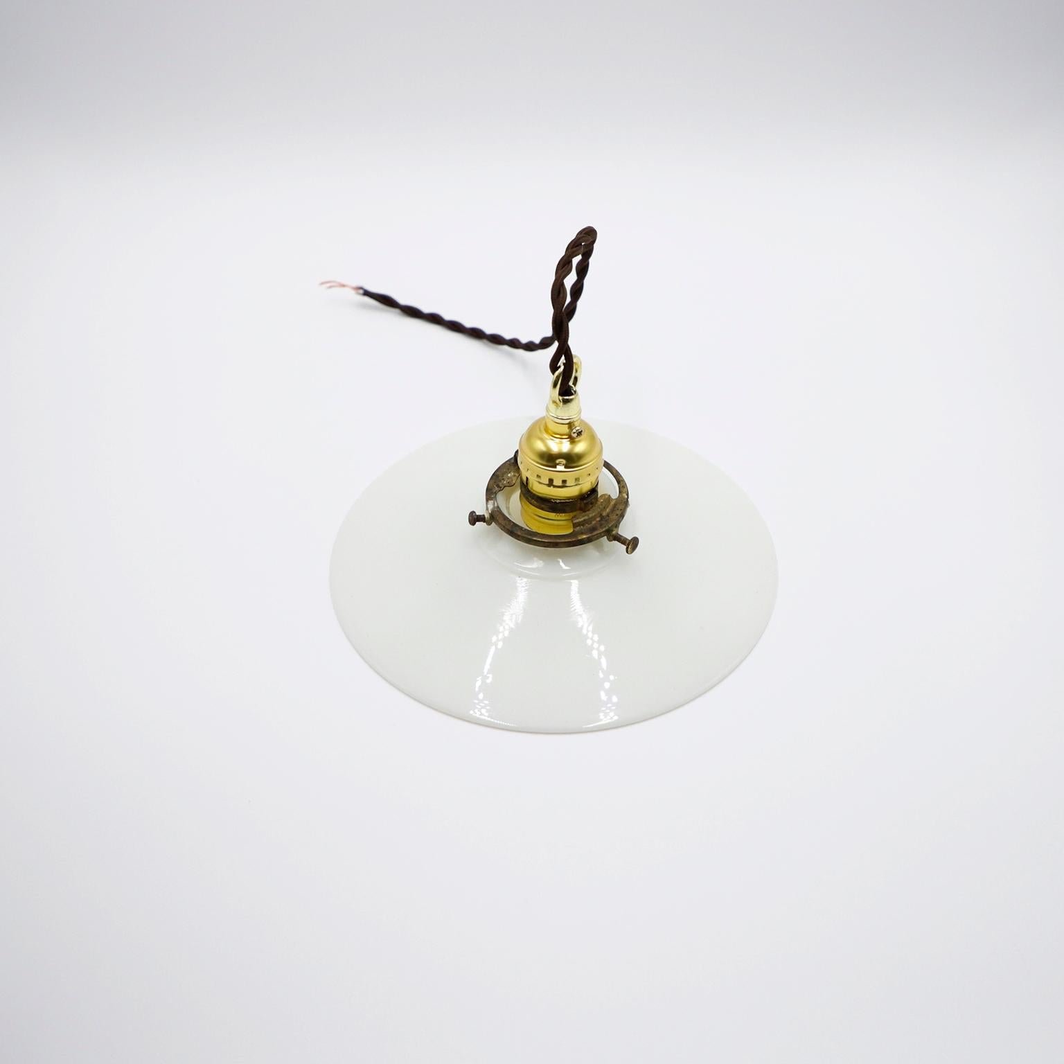 We offer this Milk Glass Vintage Industrial Pendant Light. Glass shade in excellent condition. The electrical system is new and works perfectly.