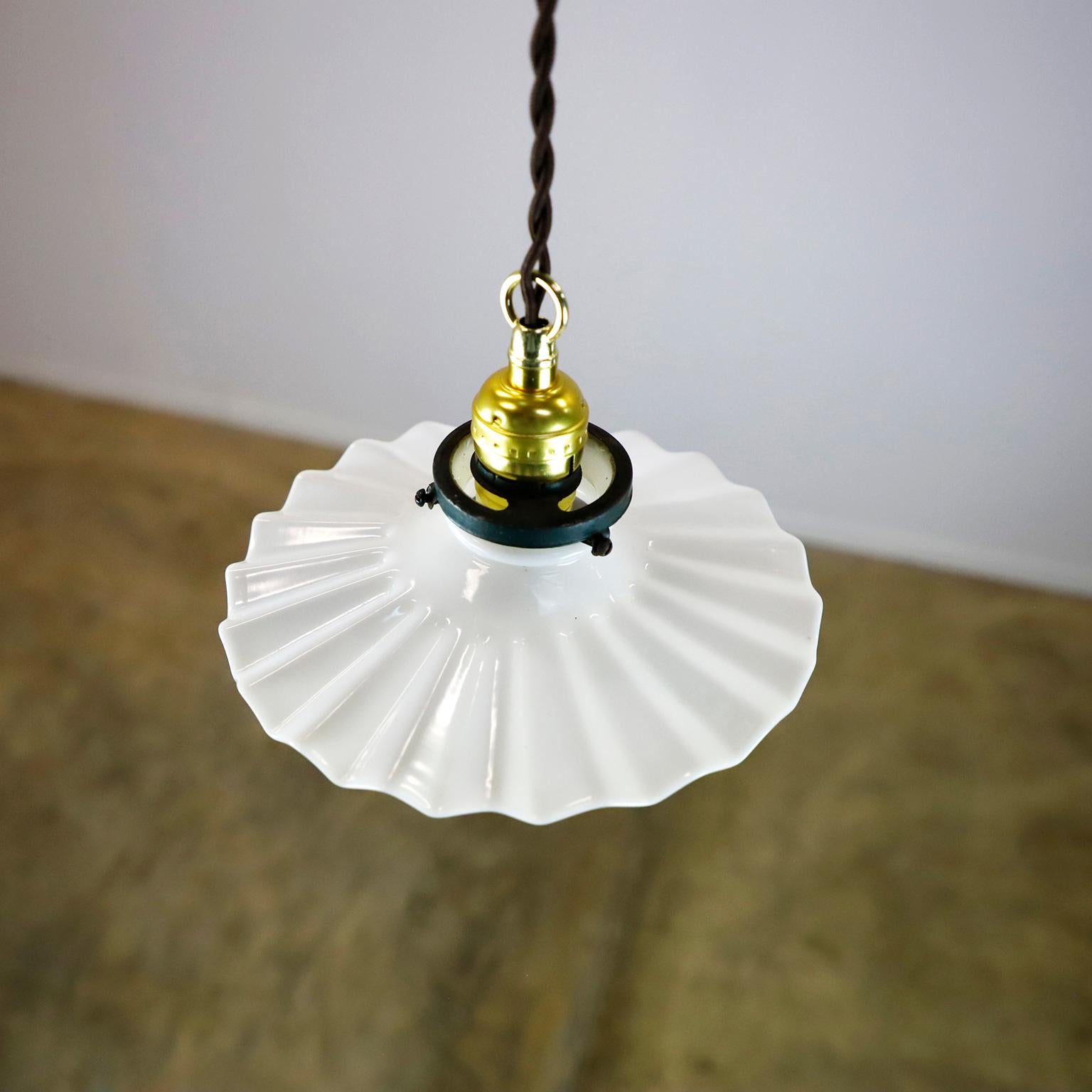 We offer this Milk Glass Vintage Industrial Pendant Light. Glass shade in excellent condition. The electrical system is new and works perfectly.