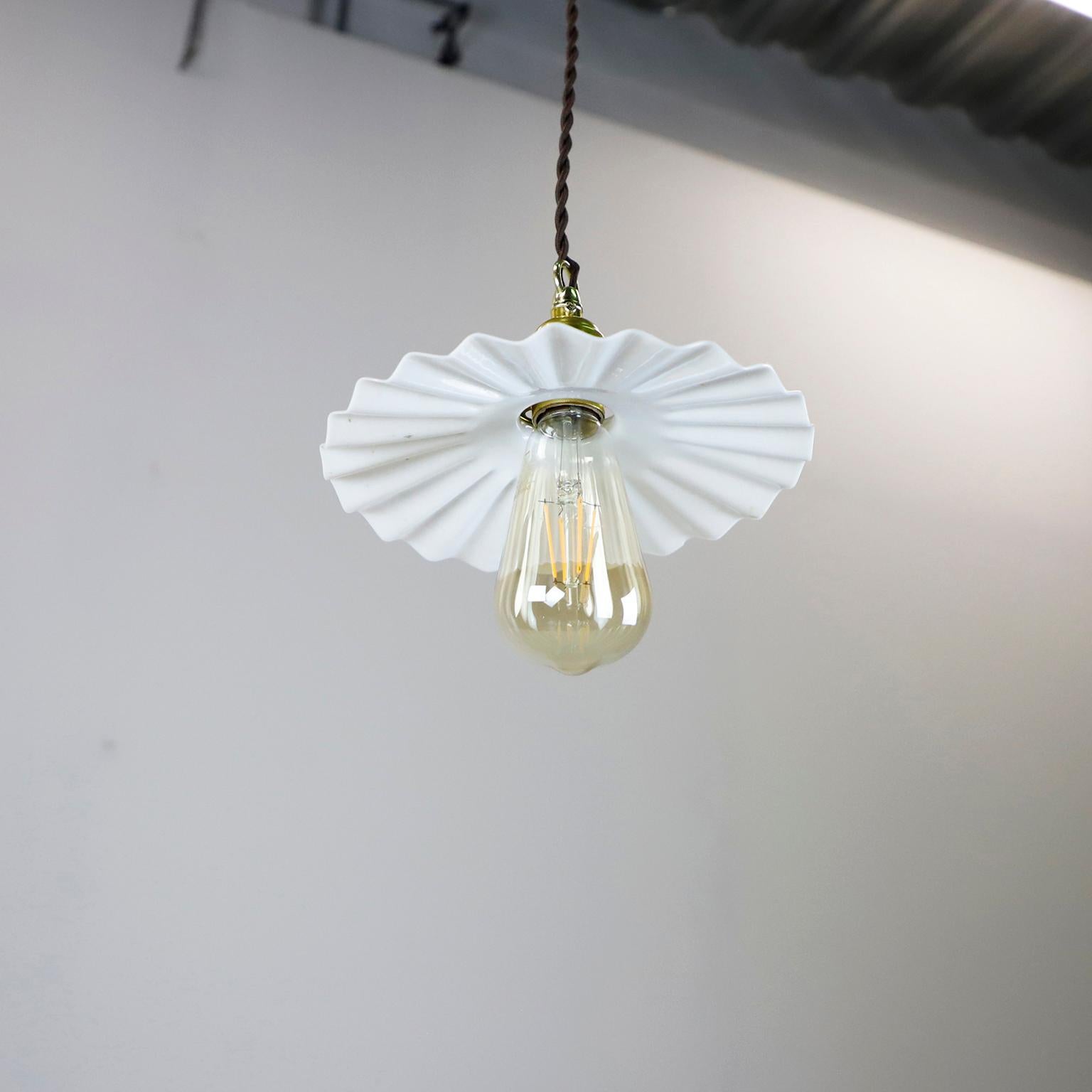 We offer this Milk Glass Vintage Industrial Pendant Light. Glass shade in excellent condition. The electrical system is new and works perfectly.