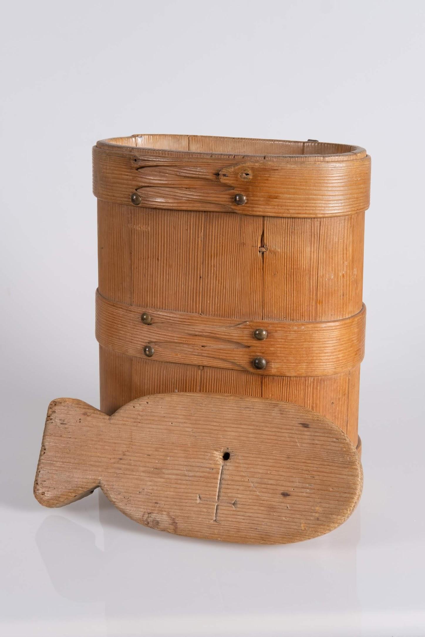 This container was one fitted with a leather or fabric strap to be carried on the shoulders. It was used to carry milk.