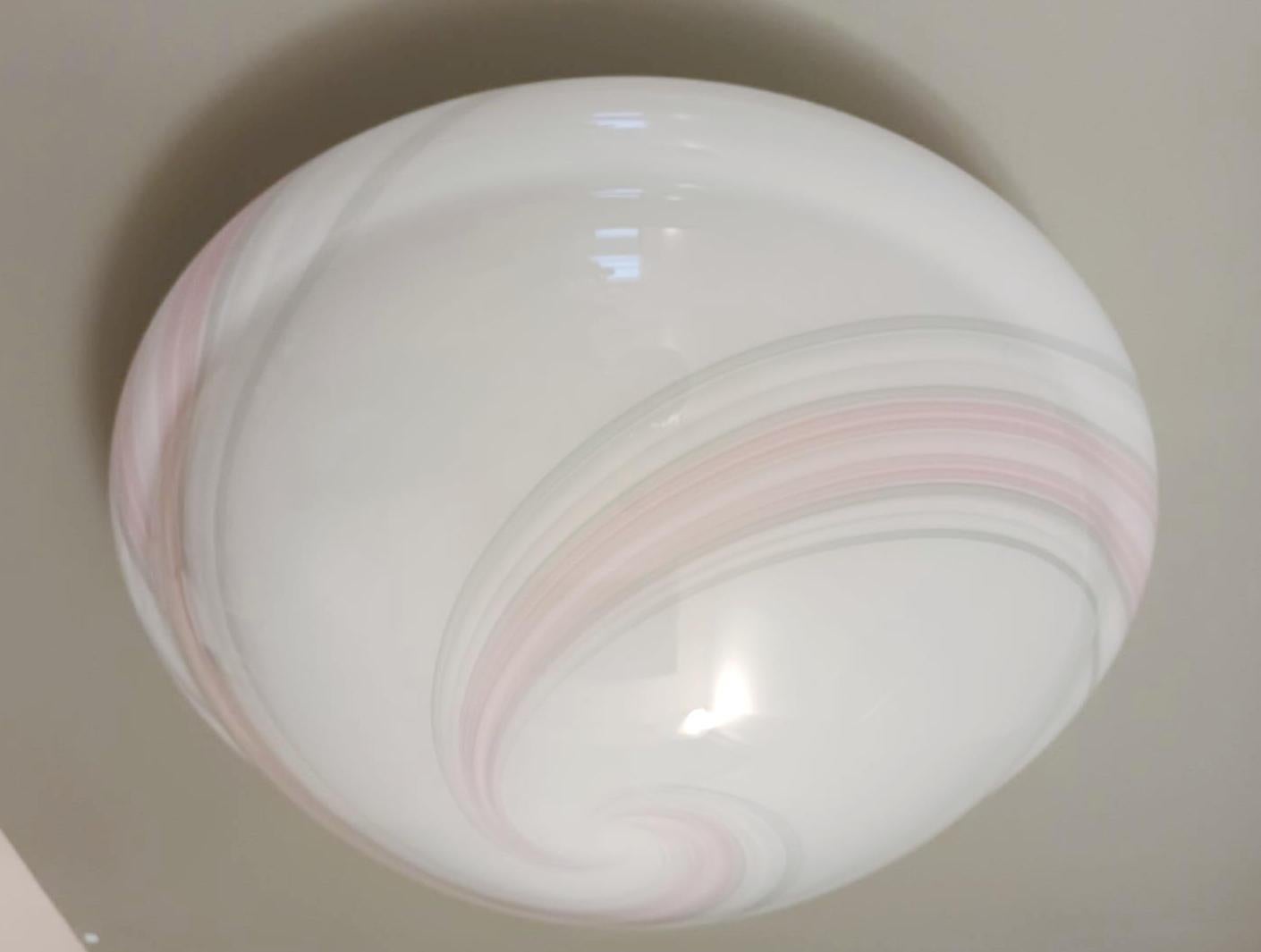 Vintage Italian flush mount or wall light with a single milky white Murano glass shade decorated with pink ribbed spirals / Made in Italy circa 1960s.
Measures: diameter 18 inches, height 8 inches
1 lights / E26 or E27 type / max 60W.
1 available in