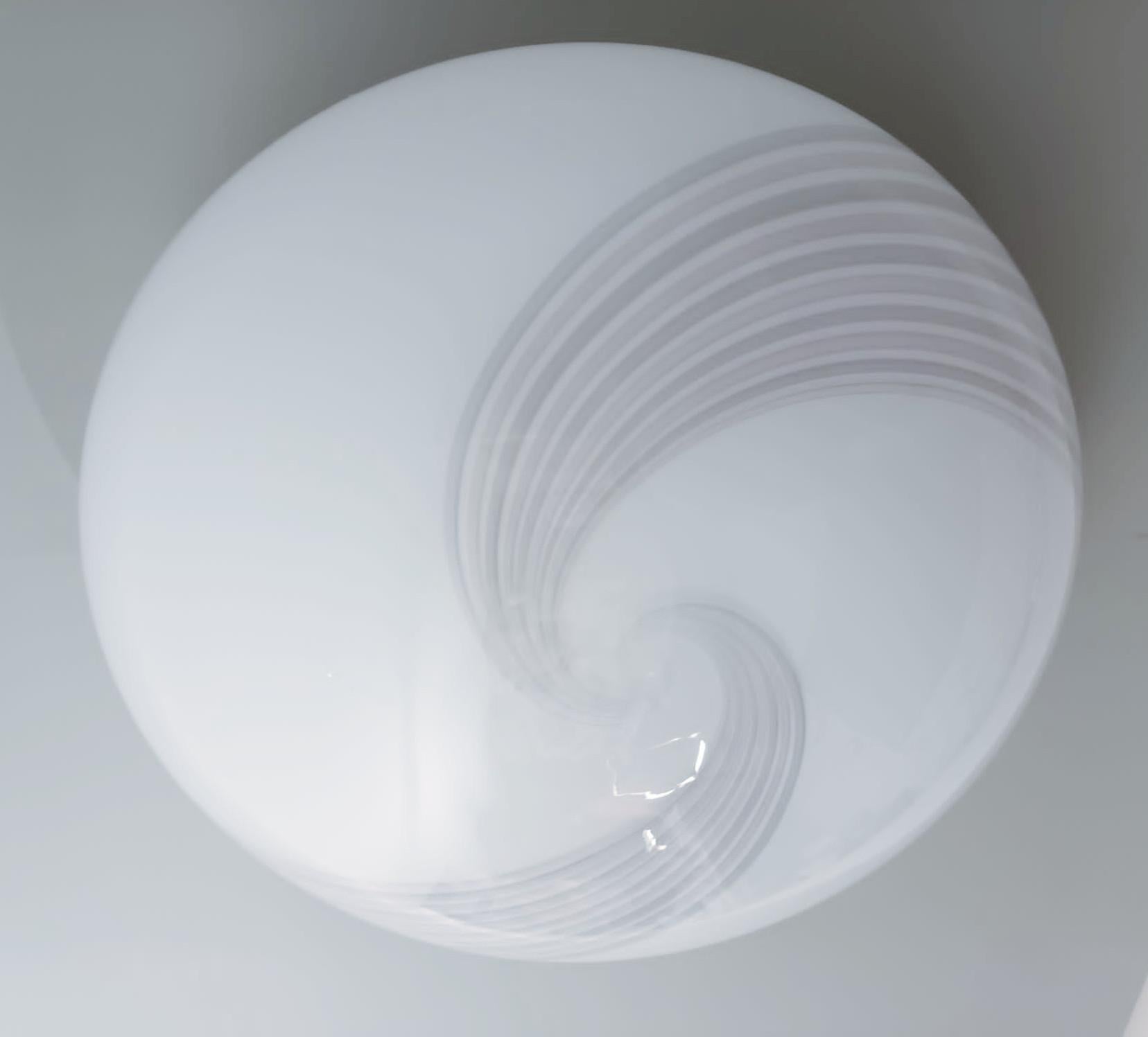 Vintage Italian flush mount or wall light with a single milky white Murano glass shade decorated with ribbed spirals / Made in Italy in the style of Venini, circa 1960s
Measures: diameter 18 inches, height 8 inches
3 lights / E26 or E27 type / max