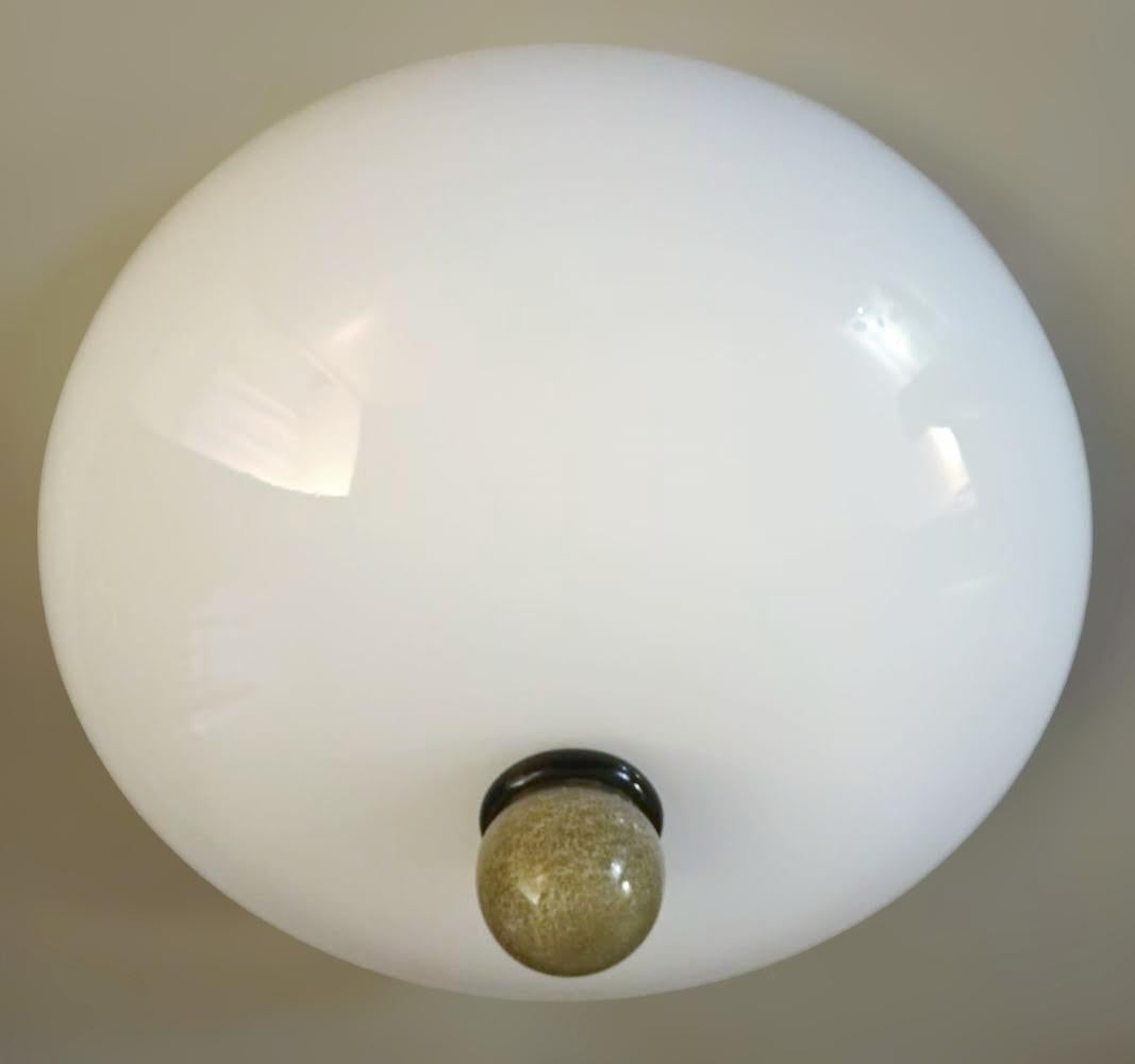 Vintage Italian flush mount with a milky white glass shade and a black with amber glass finial / Made in Italy in the style of Venini, circa 1960s 
Measures: diameter 16 inches, height 8 inches
2 lights / E12 or E14 type / max 40W each
1 available