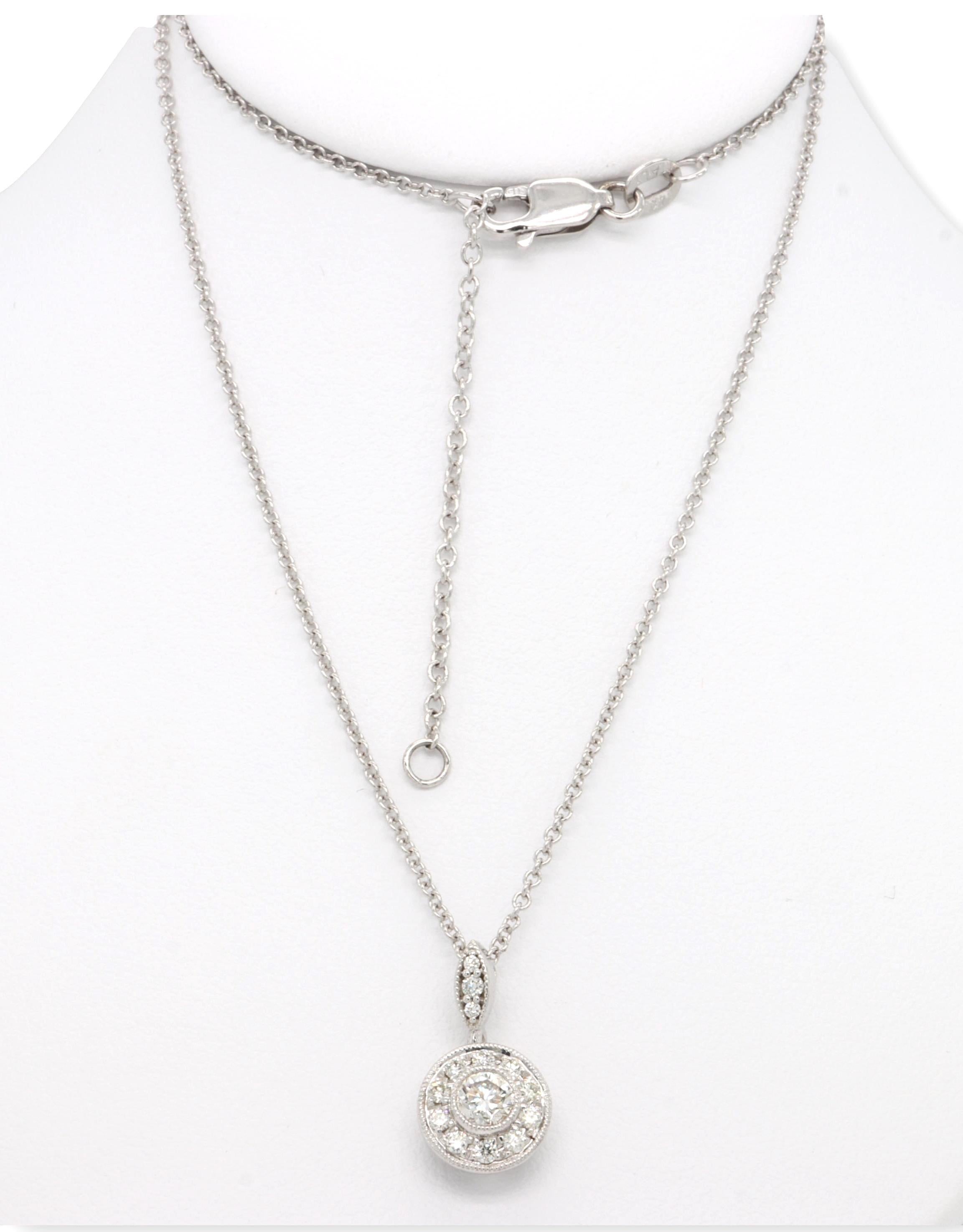 Circle Necklace featuring a center round slide pendant finely crafted in 18 karat white gold with a round brilliant cut diamond weighing 0.15 carats inside a mill-grain bezel, G color VS clarity surrounded by 10 round brilliant cut diamonds weighing