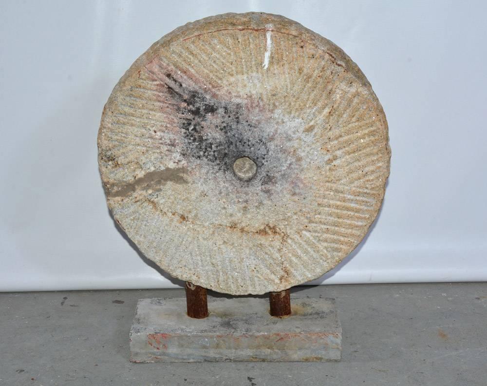 Beautiful antique specimen of mill stone mounted on stand in the style of Bi disc.