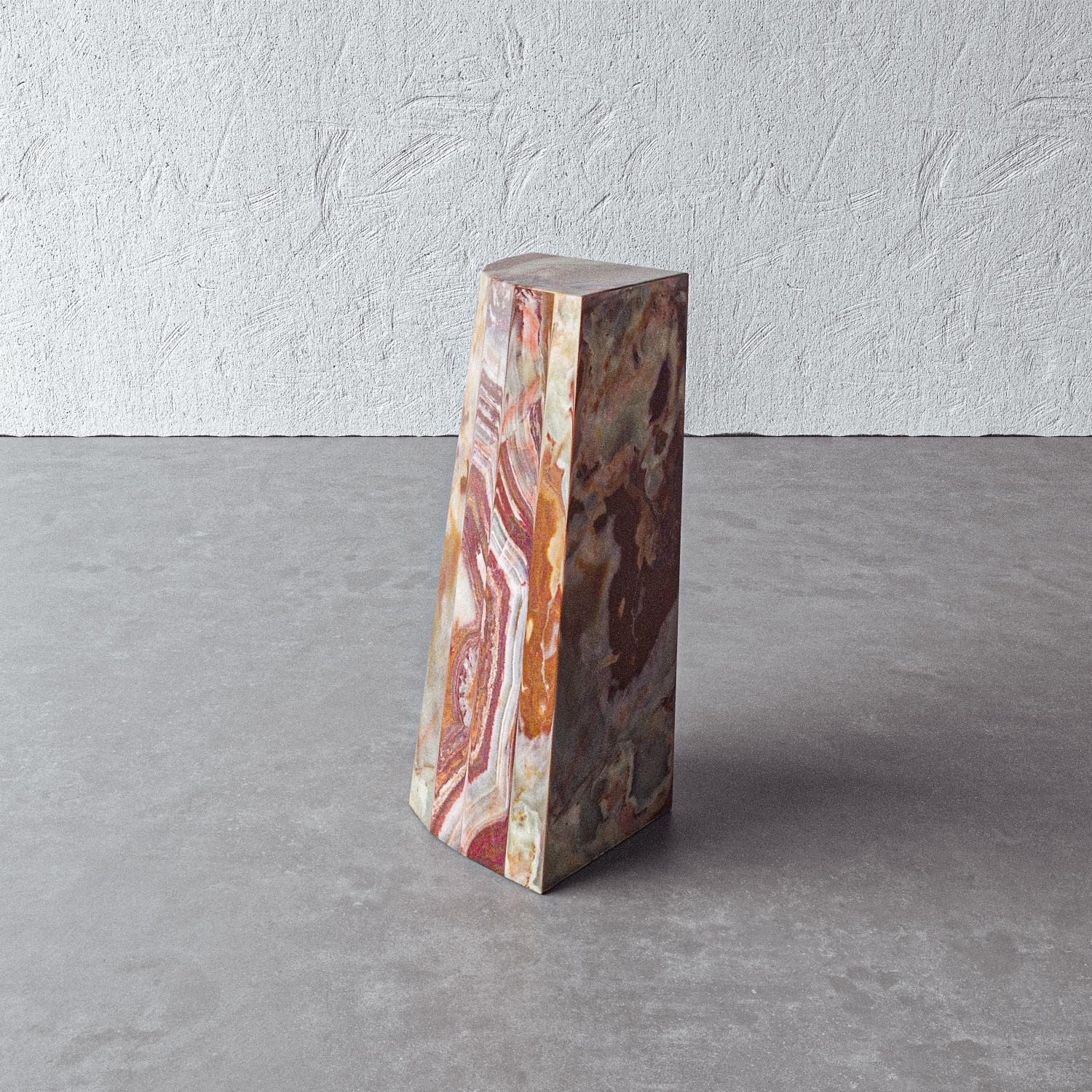 Red dragon onyx forms a functional side table that also works as a pedestal or stand-alone accent sculpture. Stackable. Handmade by artisans in Vietnam, the piece adds a bold dimension to any space.

