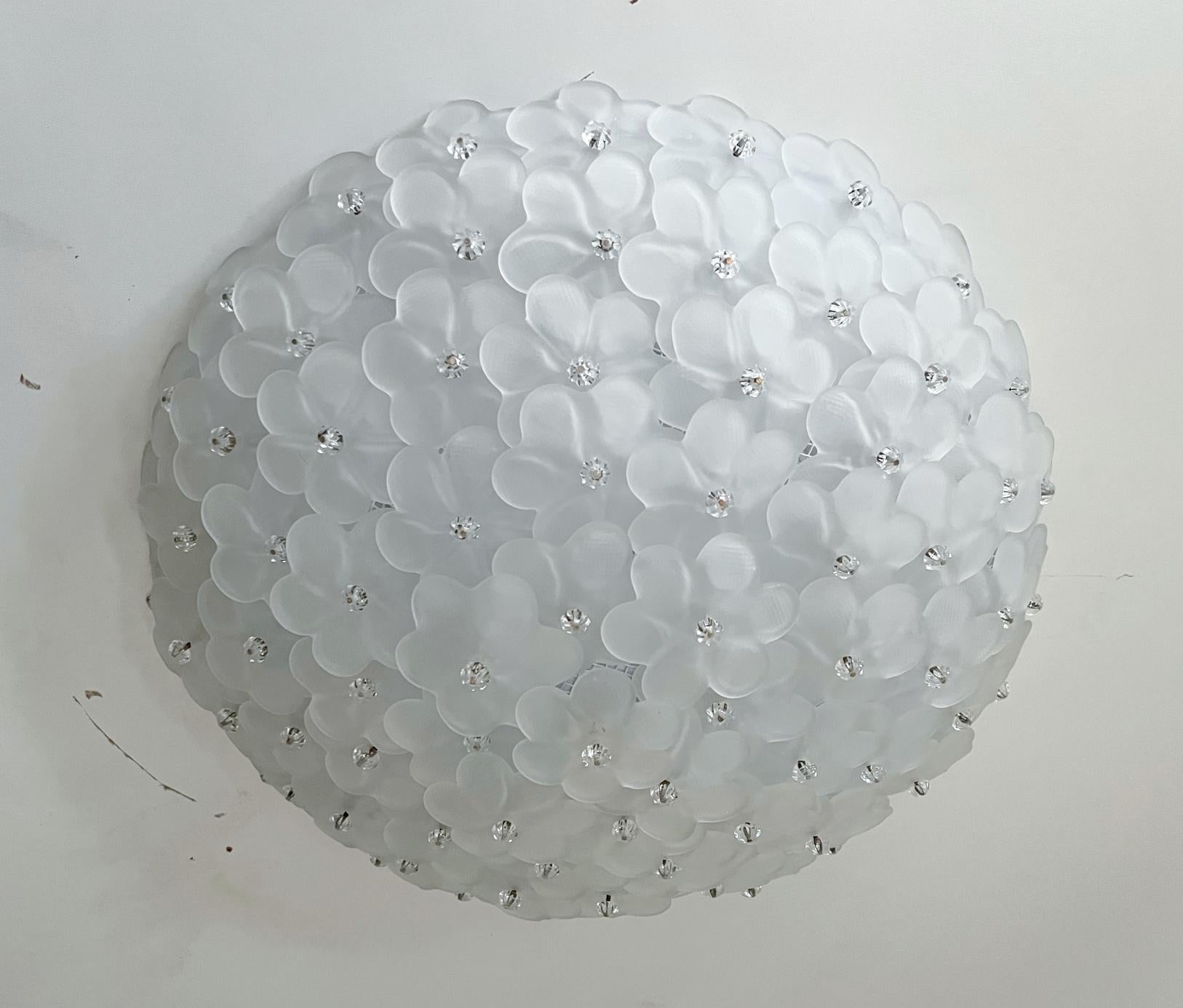 Italian flush mount with frosted white Murano glass flowers intricately layered on white metal frame and secured with glass screws / Made in Italy
6 lights / E12 or E14 type / max 40W each
Measures: Diameter 20 inches, height 7 inches
Order only /