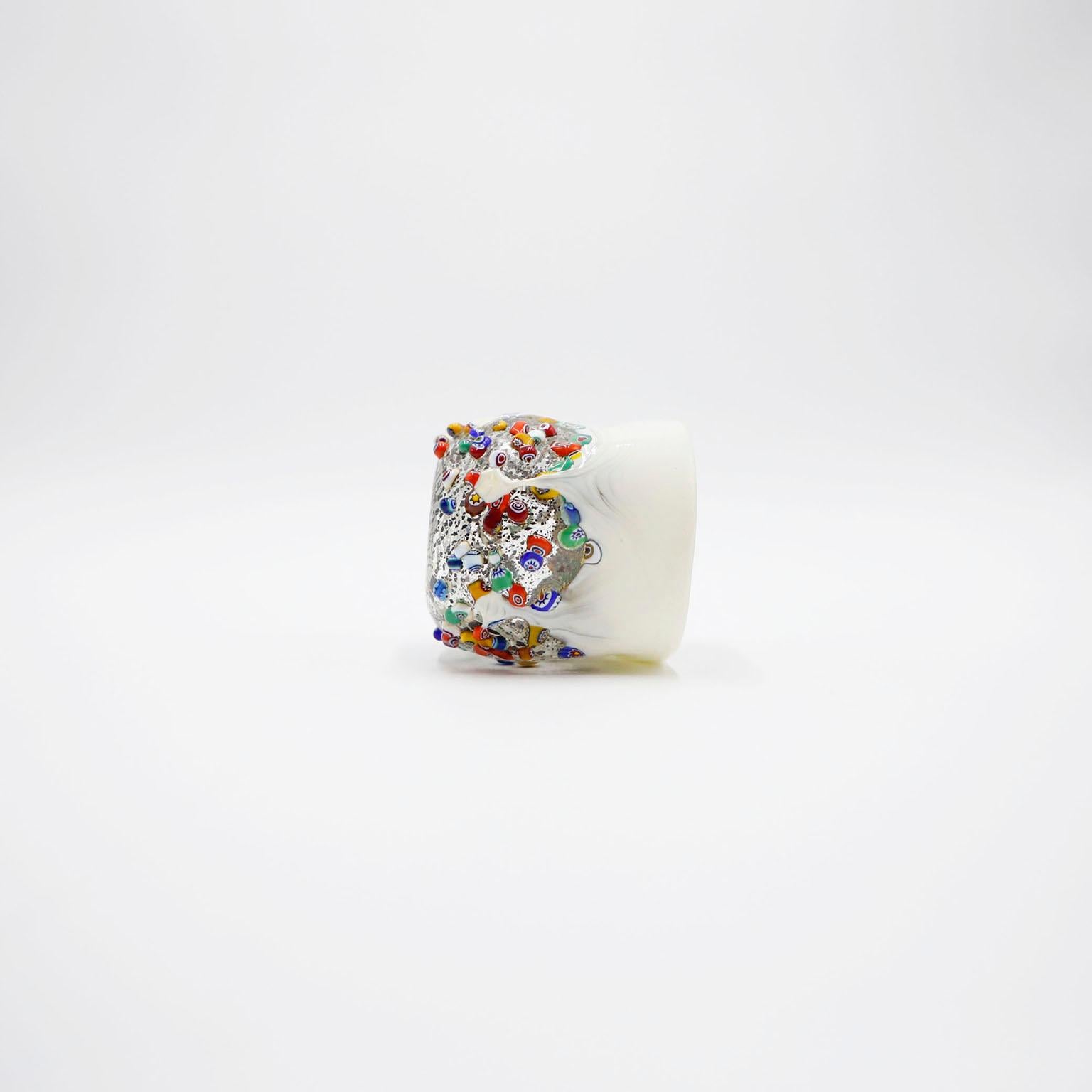 Gorgeous Murano dimpled crumpled glass millefiori tumbler. Made with murrine glass and embossed with silver leaf and multicolored. Handmade, one-of-a-kind glass, each piece are signed.

Add this beautiful piece to your glass collection or display on