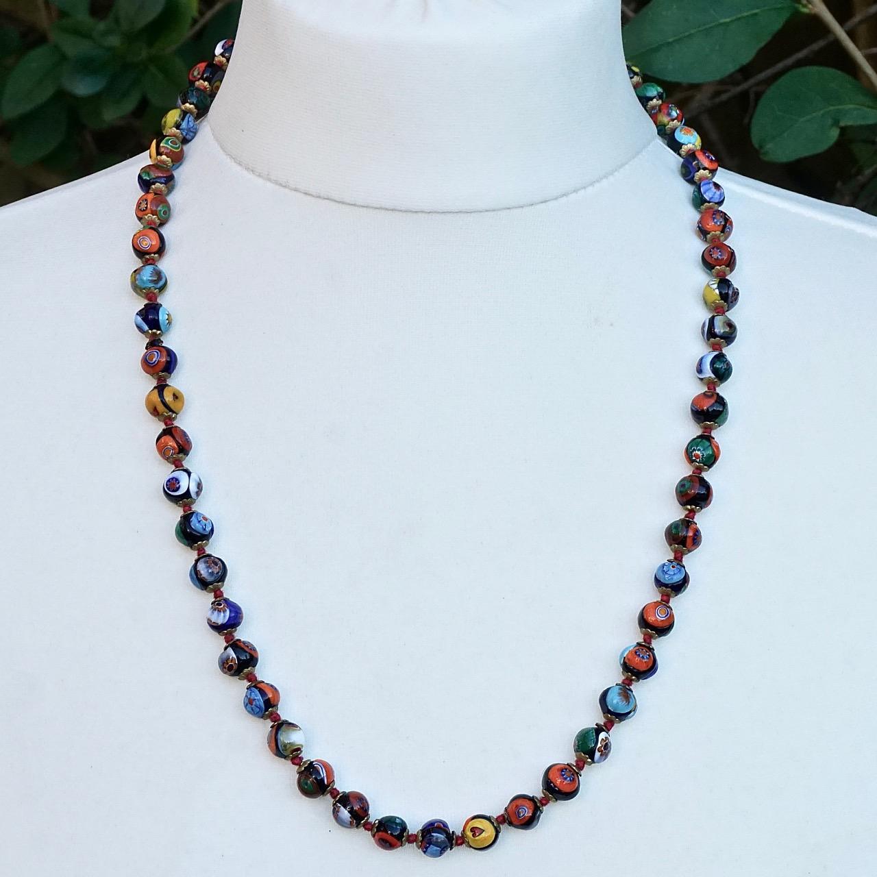 Millefiori murano glass bead necklace on red knotted thread, with gold tone caps and a barrel clasp. The lovely colourful beads are hand made. Measuring length 64cm / 25.2 inches, and the beads are 9mm / .35 inch. The necklace is in very good