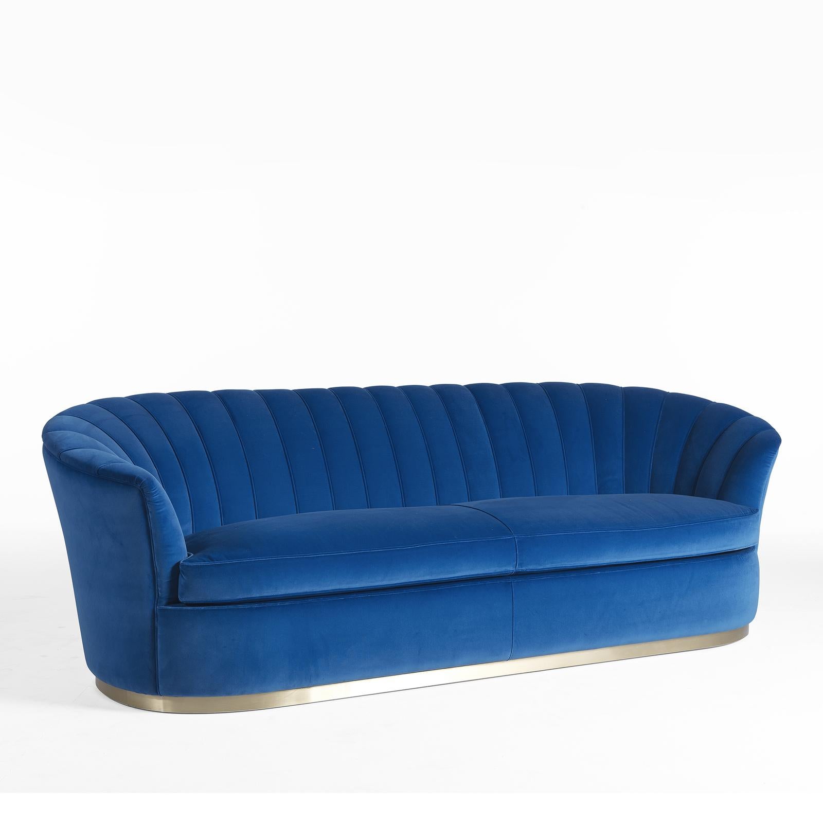 This captivating sofa makes a statement with its bold colors and classic silhouette. A contemporary reinterpretation of an antique cabriole sofa, the solid-wood frame boasts a curved back flowing into the sloped armrests creating a soft, inviting