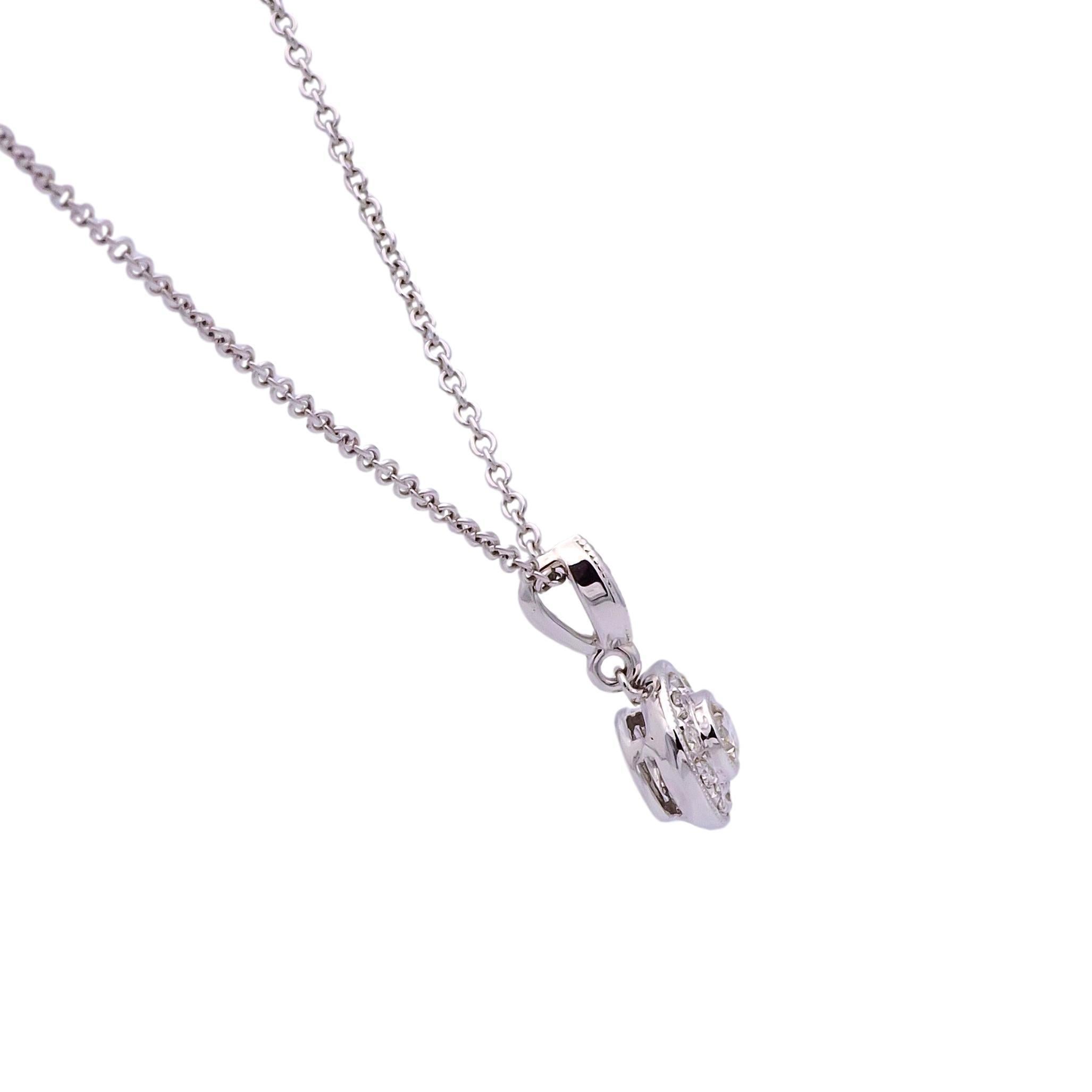 Circle Necklace featuring a center round slide pendant finely crafted in 18 karat white gold with a round brilliant cut diamond weighing 0.15 carats inside a mill-grain bezel, G color VS clarity surrounded by 10 round brilliant cut diamonds weighing