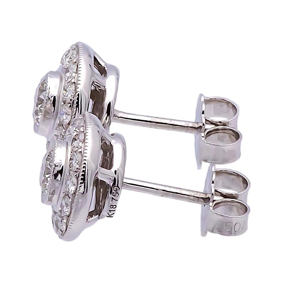 Pair of circle diamond earrings finely crafted in 18 karat white gold featuring two center round brilliant cut diamonds set in a mill-grain bezel weighing 0.20 carats each approximately G color VS2-SI2 clarity, surrounded by 14 round brilliant