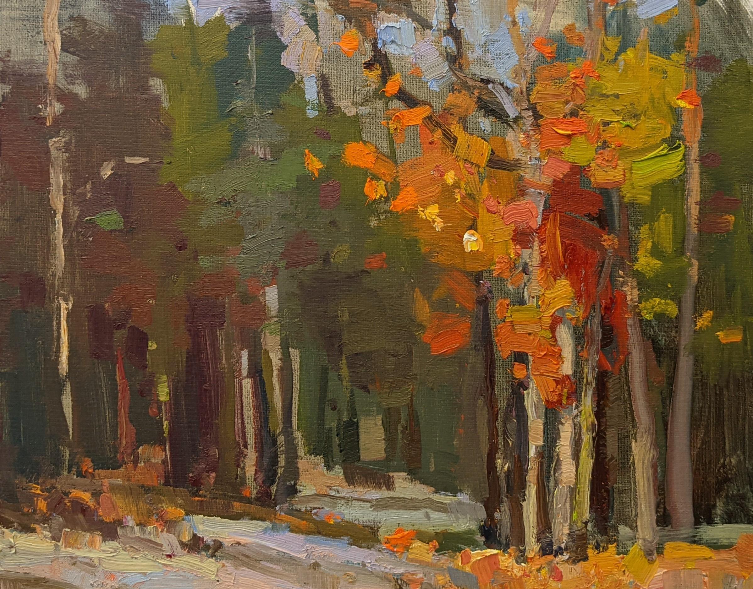 'Autumn Trail' is a framed Impressionist plein air landscape painting created by American artist Millie Gosch in 2021. Featuring a rich palette mostly made of blue, green, red and orange tones, this oil on canvas painting depicts an exquisite