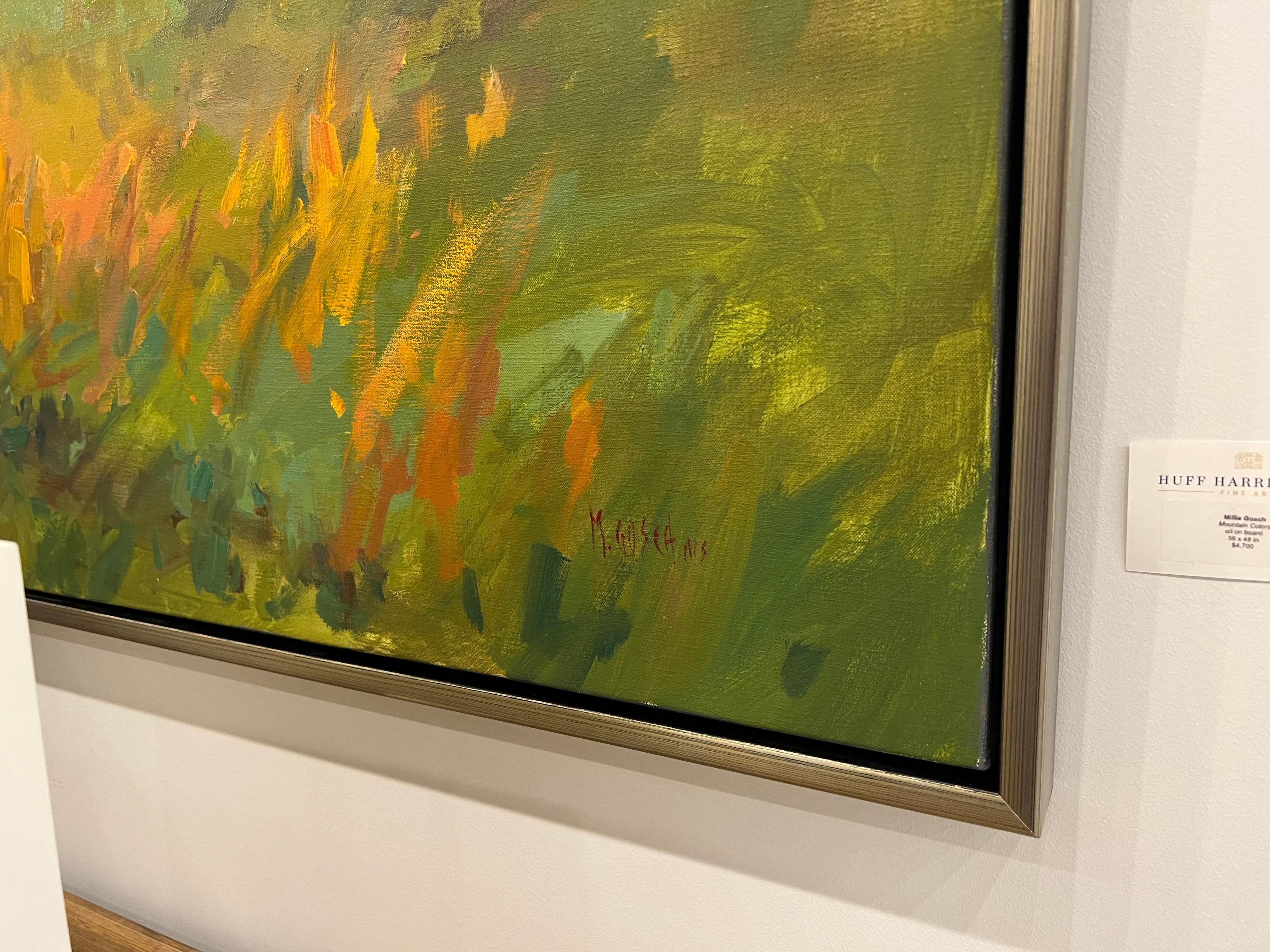 'Mountain Colors' is a framed Impressionist plein air landscape painting created by American artist Millie Gosch in 2021. Featuring a rich palette mostly made of blue, green, pink and orange tones, this oil on canvas painting depicts an exquisite