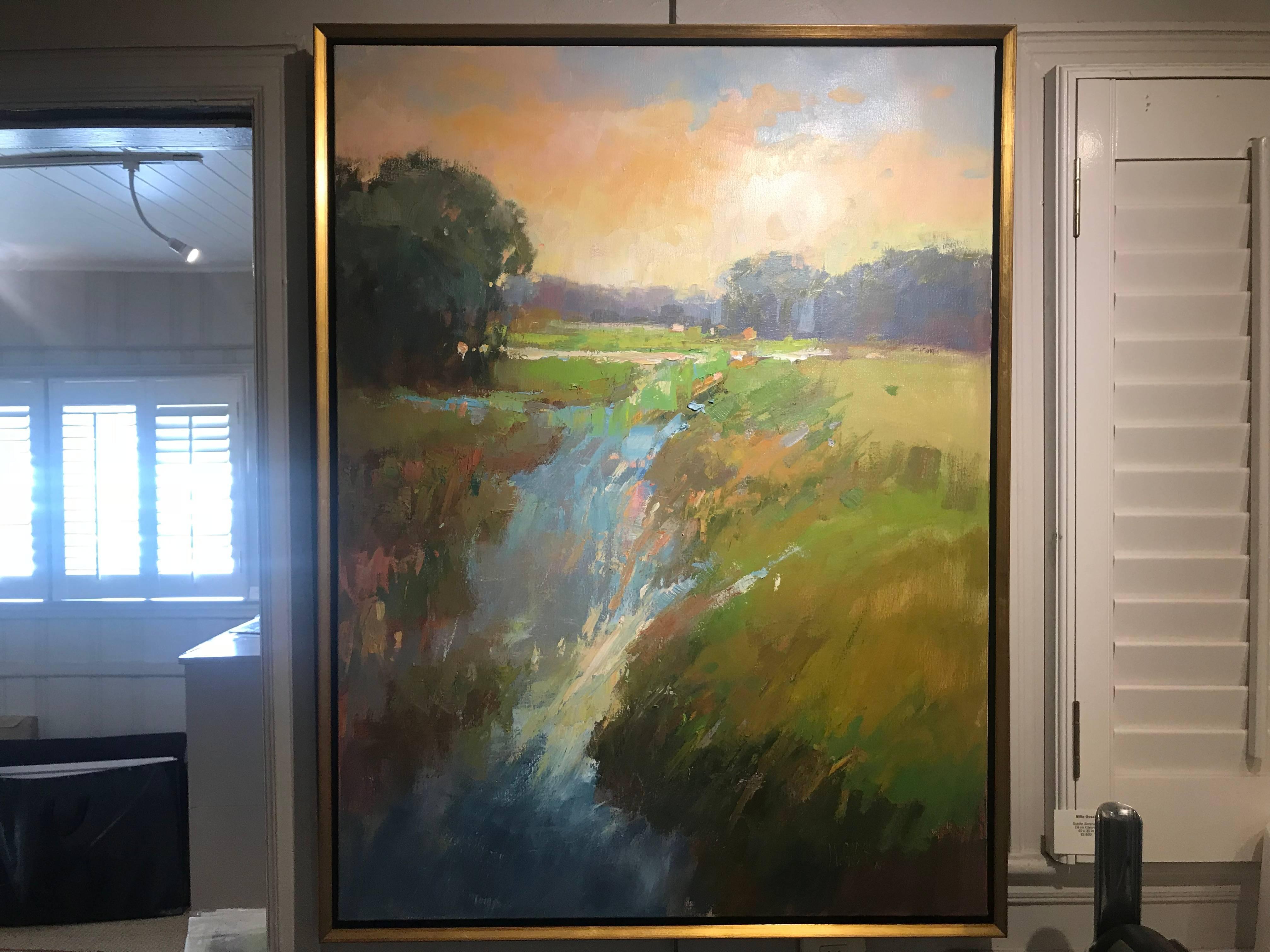 'Subtle Serenade' is a framed Impressionist plein-air landscape painting created by American artist Milly Gosch in 2018. Painted in a vertical format, this oil on canvas piece features a serene view of a meadow, accented by the presence of a few