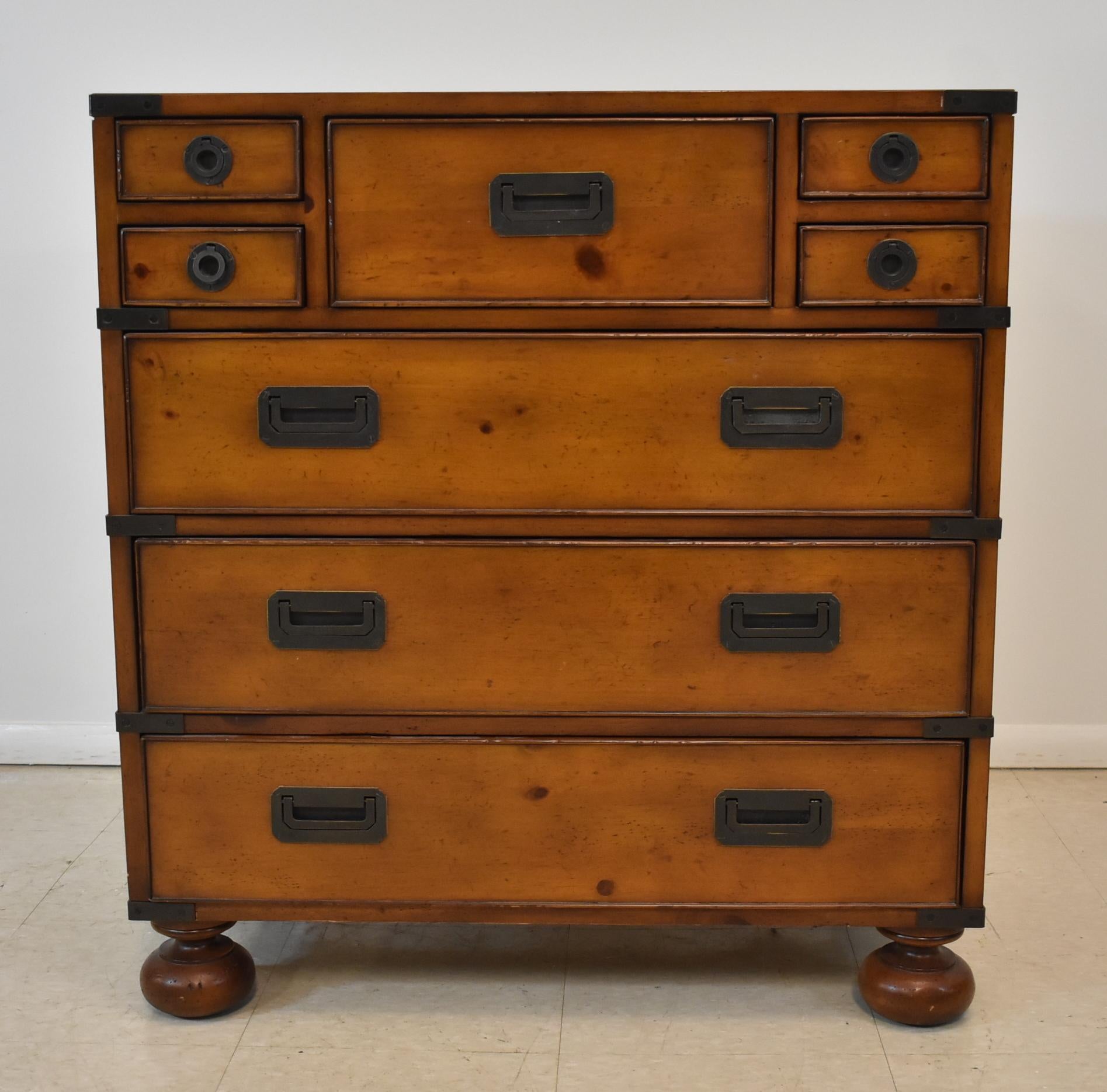 Milling Road collection division of Baker Furniture Campaign chest. Eight drawers have iron corner bands. Bun feet. Distressed factory finish in very good condition. Top has a couple small finish spots.