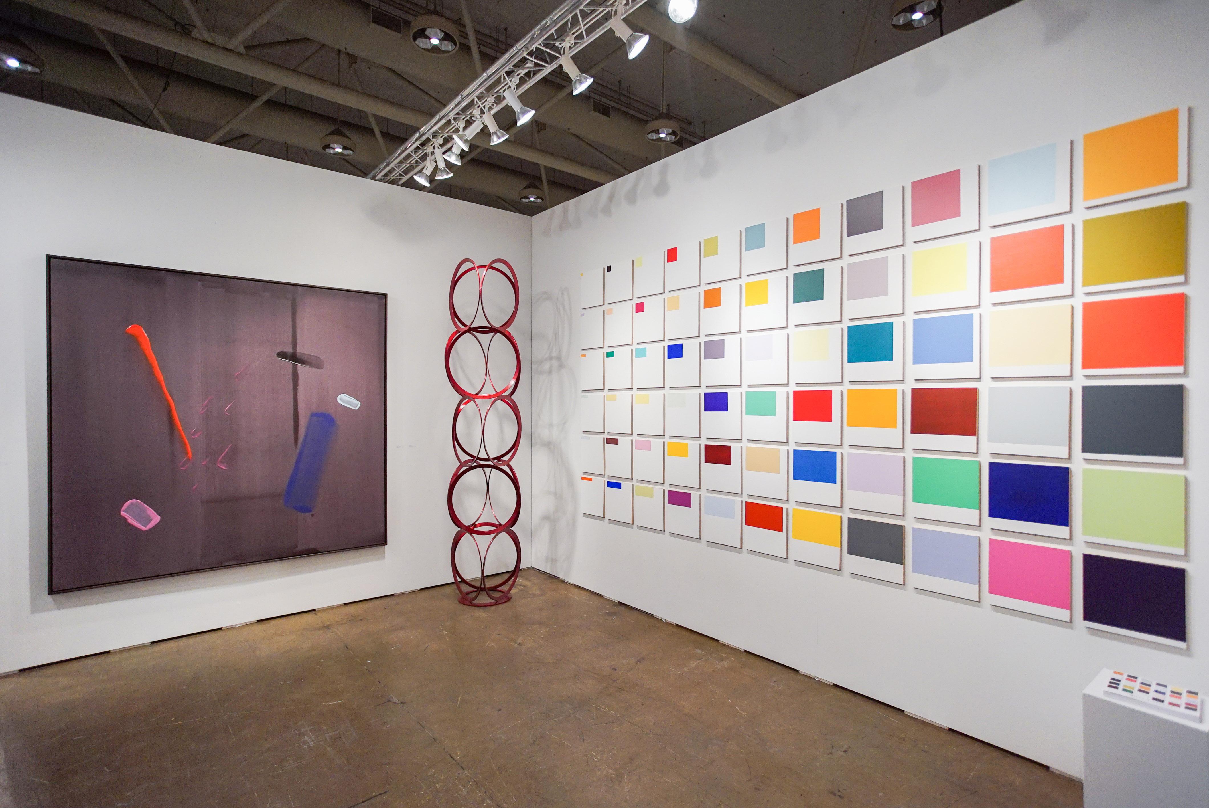 A monumental work, comprised of 66 small square panels, each painted with a single orthogonal, are installed in a precise grid: six high and ten across. The orthogonal panels are painted in solid, specific colors with the area of each increasing