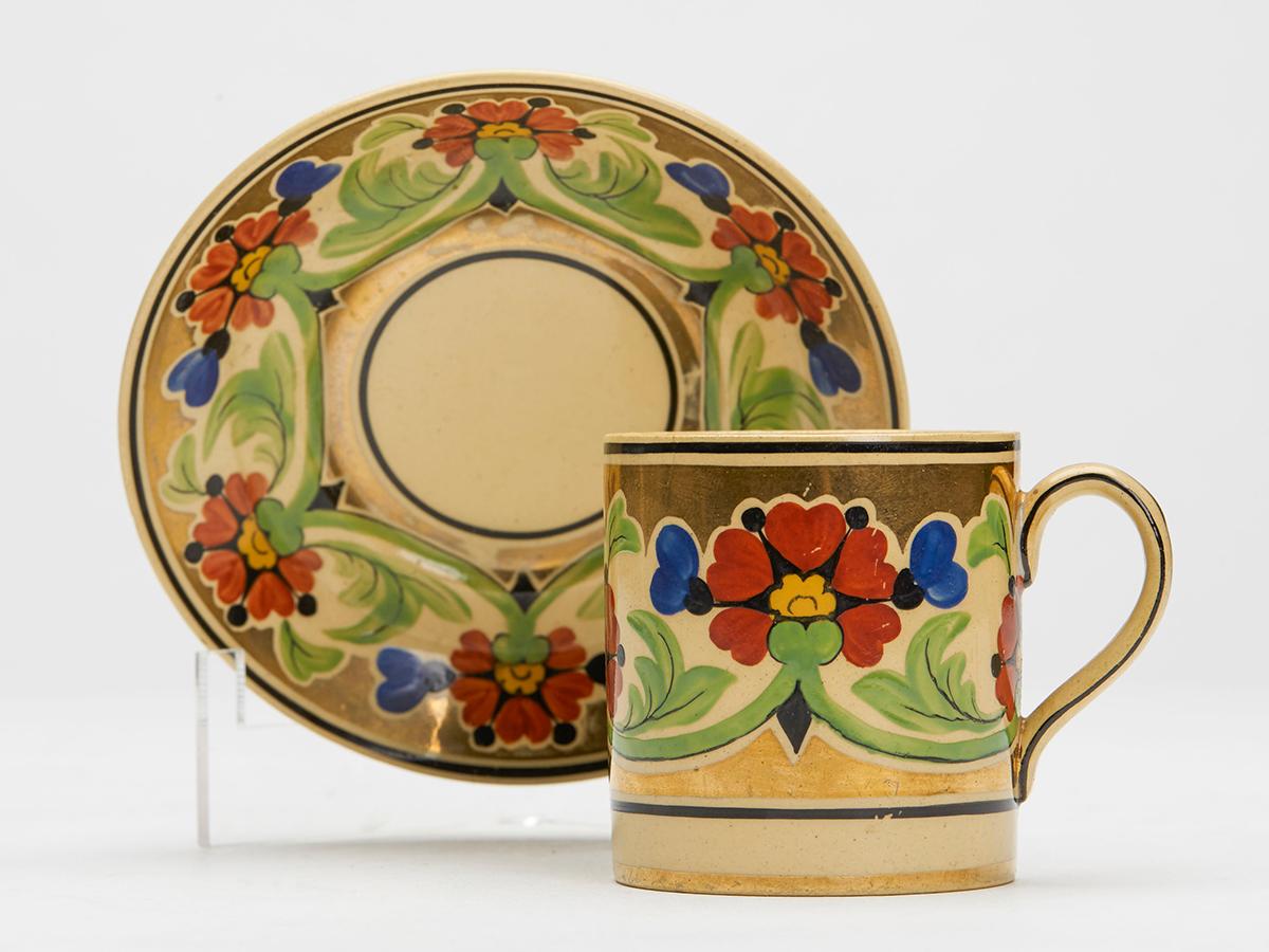 A very fine Art Deco Wedgwood floral cabinet coffee can and saucer by renowned designed Millicent (Millie) Jane Taplin (British, 1902-1980) and dating from around 1930. 

Millie was a renowned painter of ceramics who was trained by Alfred and Louise