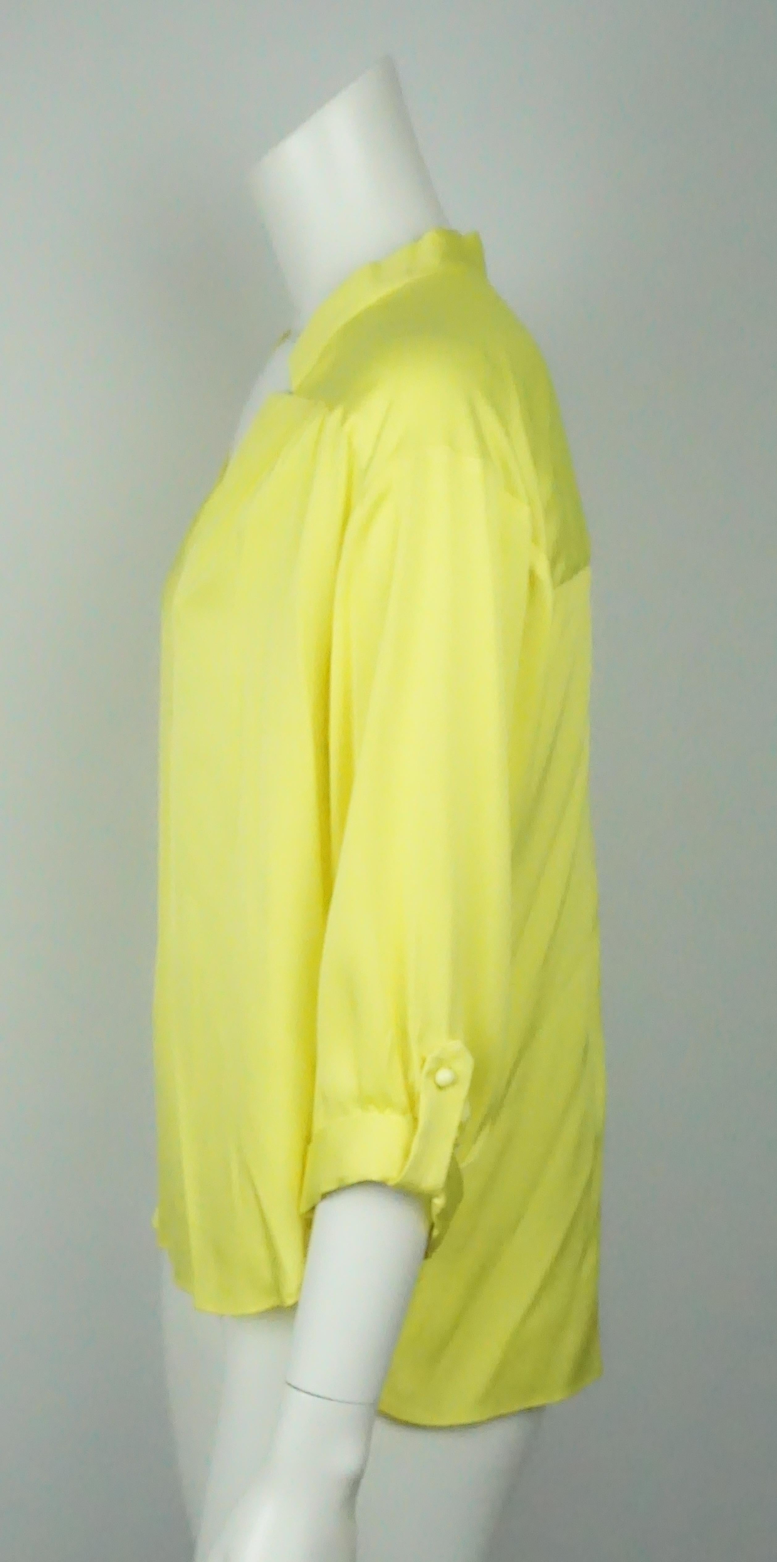 Milly Yellow Silk 3/4 Sleeve Top - 8  This simple yet beautiful top is in excellent condition. The neckline is trimmed with extra fabric that also has a small cutout detail. There are three yellow buttons in the middle that close the top. There is