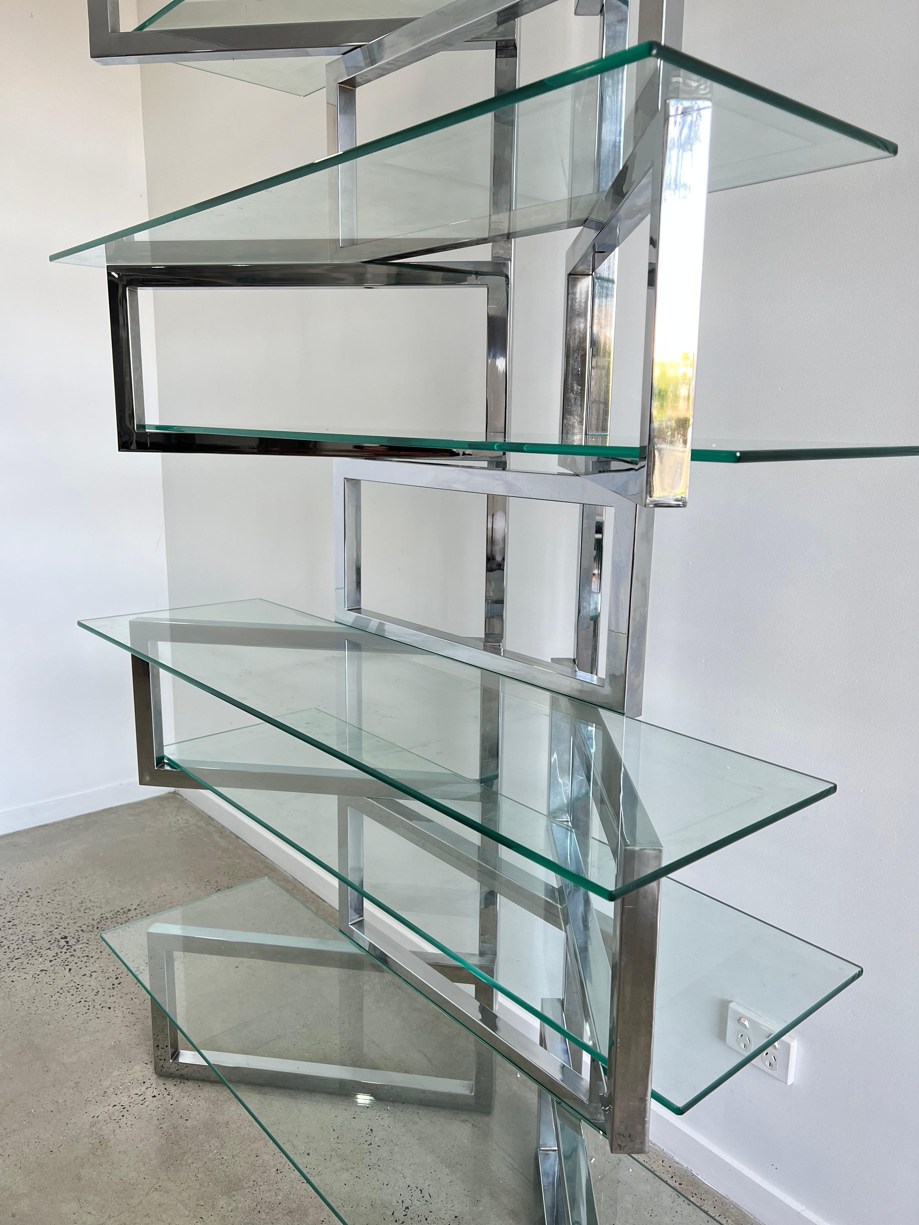 Over the top Milo Baughman chrome and glass étagère. The chrome-plated steel heavy square tubes are hinged to allow for the units panels to pivot. The chrome is very nice with only minor signs of wear. The glass shelves can be arranged in different