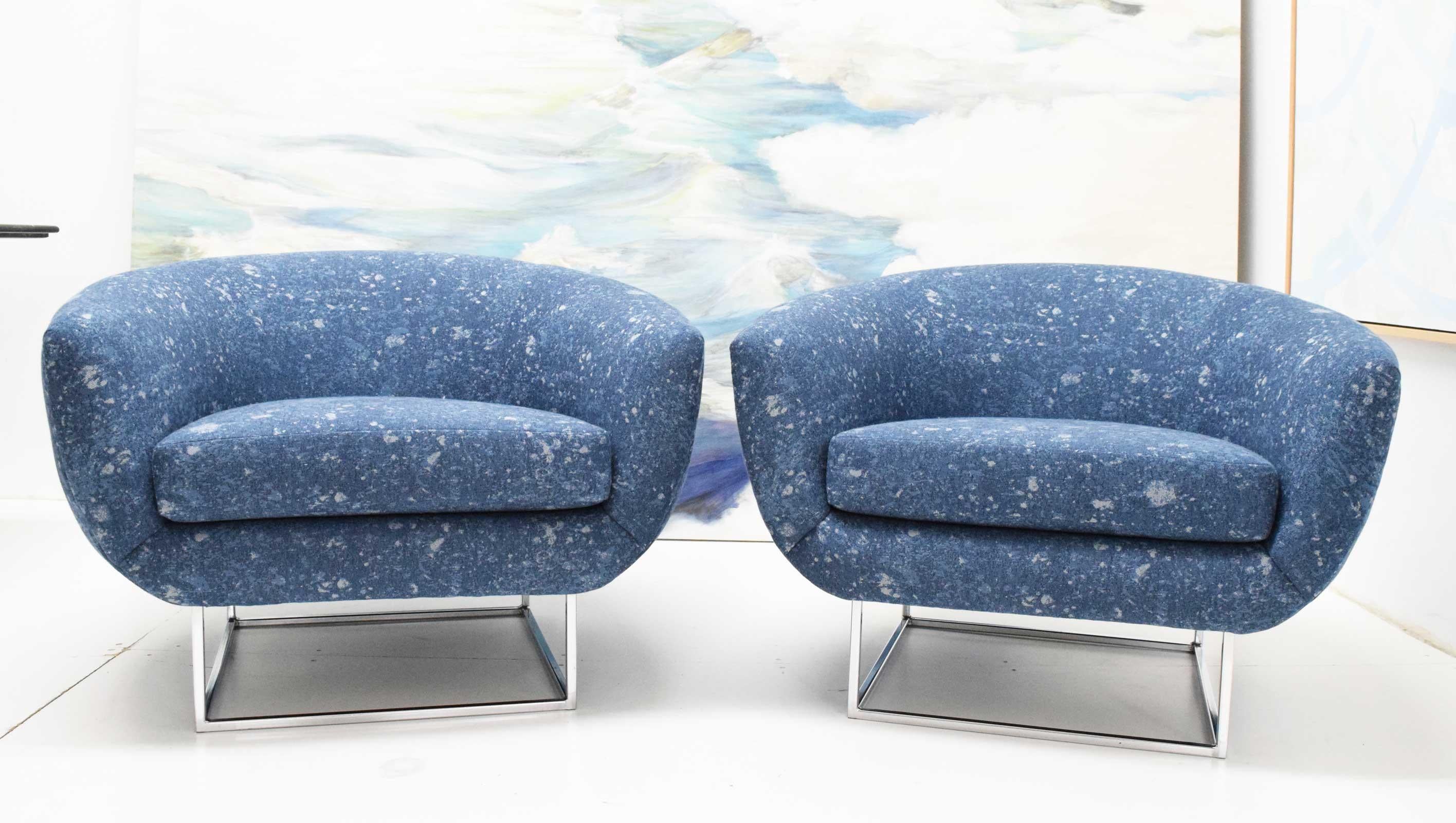 A great looking pair of overstuffed lounge chairs by Milo Baughman. You don't see these too often. They have a beautiful square chrome base. We updated the look with new upholstery by Donghia so they are fresh and ready to go.