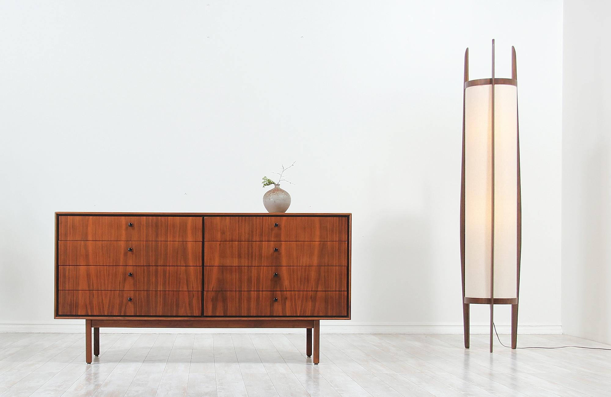 Elegant Mid-Century Modern dresser designed by Milo Baughman for Arch Gordon in the United States circa 1960s. This spectacular eight-drawer dresser features a walnut-veneered case supported by tapered legs and continuous grain that flows throughout