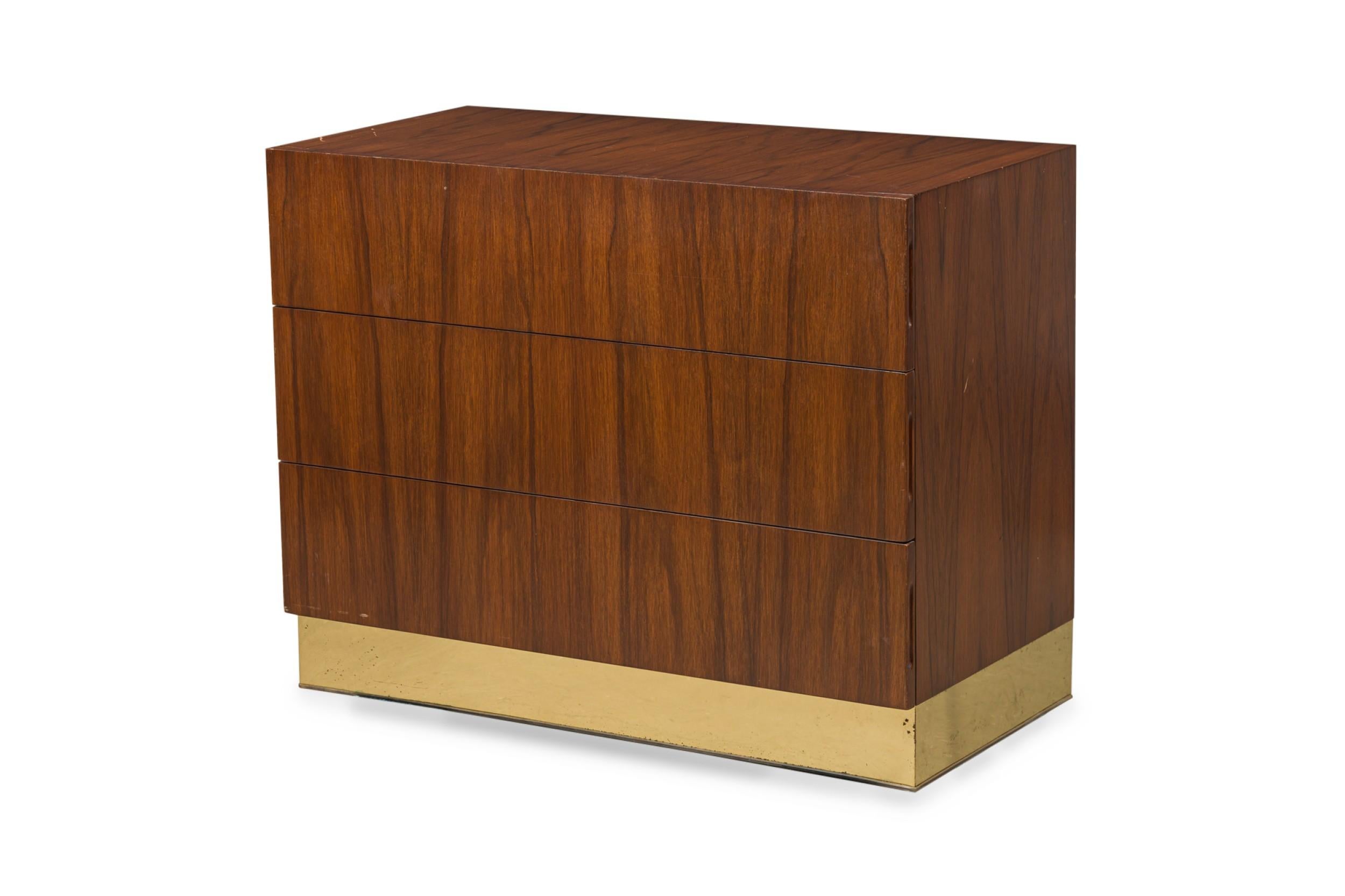 American Mid-Century 3-drawer commode / chest of drawers finished in rosewood veneer and a brass veneer band around the base. (MILO BAUGHMAN)
 

 Minor scuffs to finish on both wood and brass

