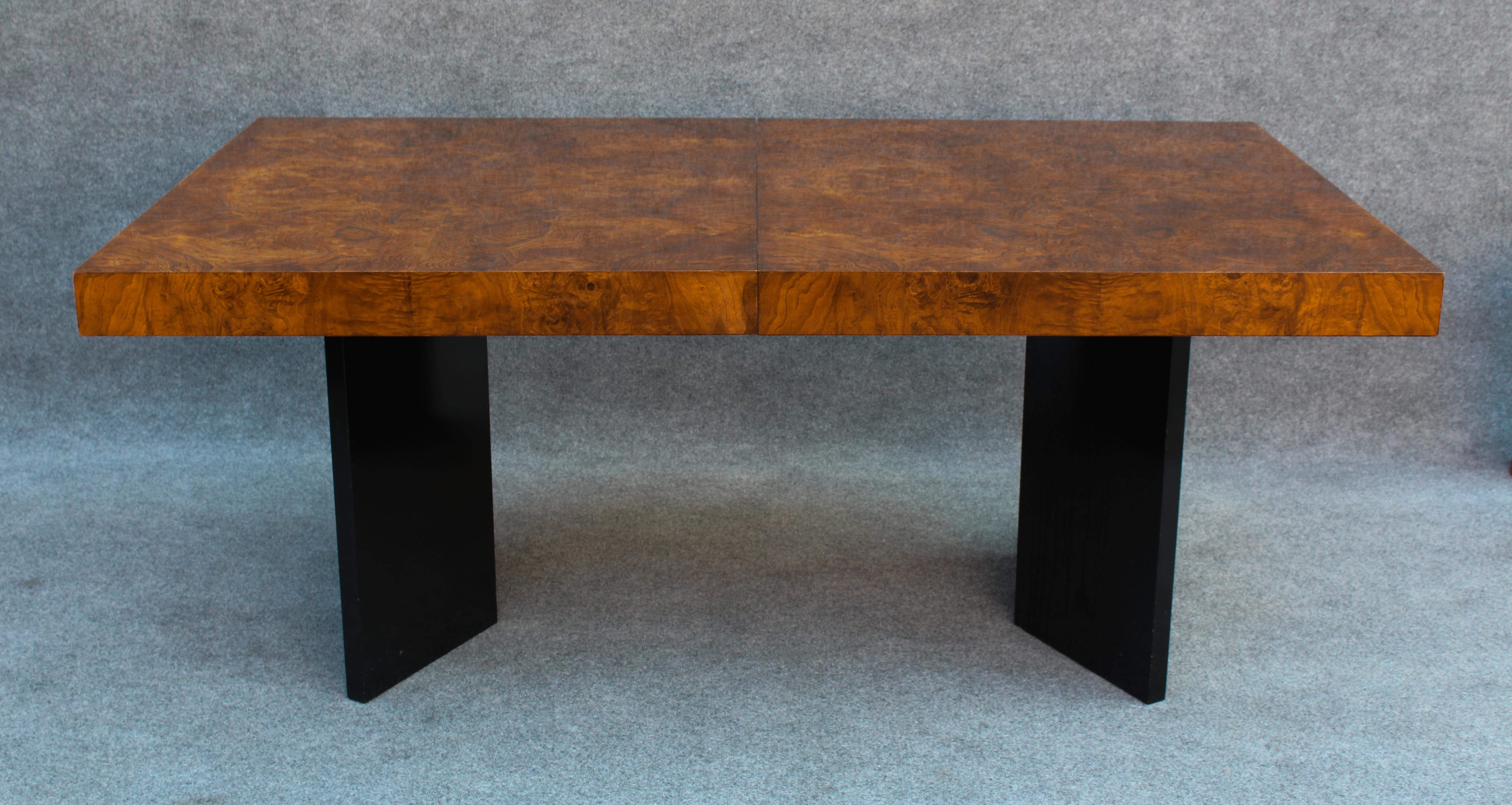 This fantastic dining table is attributed to American design legend Milo Baughman, and was likely built in the late 1970s to early 1980s. While the entire table is beautiful, the star of the show is the burl. Bookmatched to either side for a