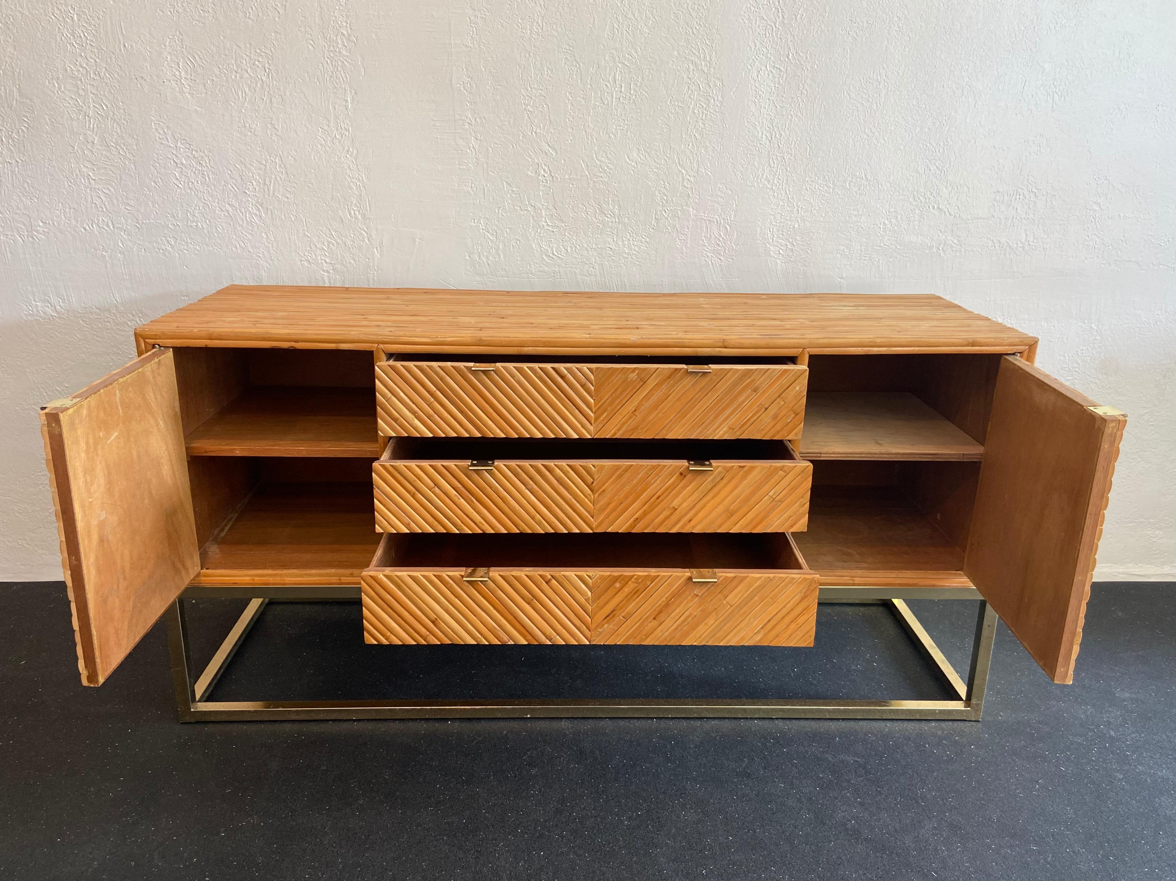 Milo Baughman attributed split bamboo and brass credenza. Rare example. Back of the credenza is also finished which allows for a floating application. Patina to the brass finish and wear to the bamboo (please refer to photos).

Would work well in