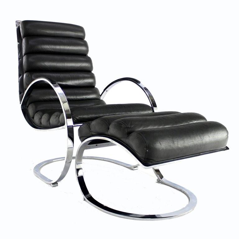 Curvaceous lounge chair and ottoman designed for Directional. This chair and ottoman is constructed of solid steel, polished chrome, with tufted black leather.