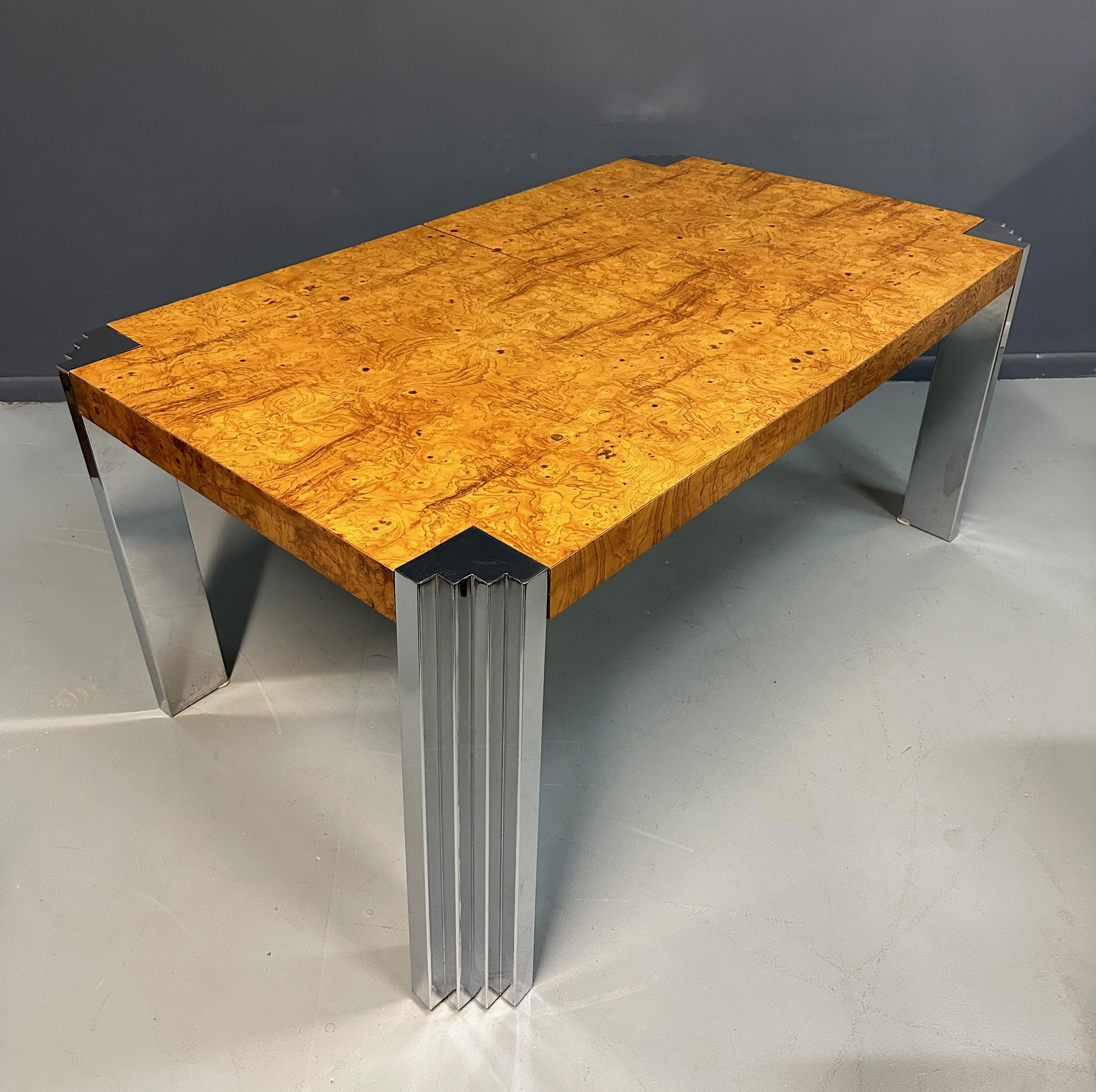 A stunning mid-century modern olive, burl wood and chrome dining table attributed to Milo Baughman for Thayer Coggin. The lines are clean and elegant. Features rich warm book-matched olive burl wood square top with detailed chrome accent to each