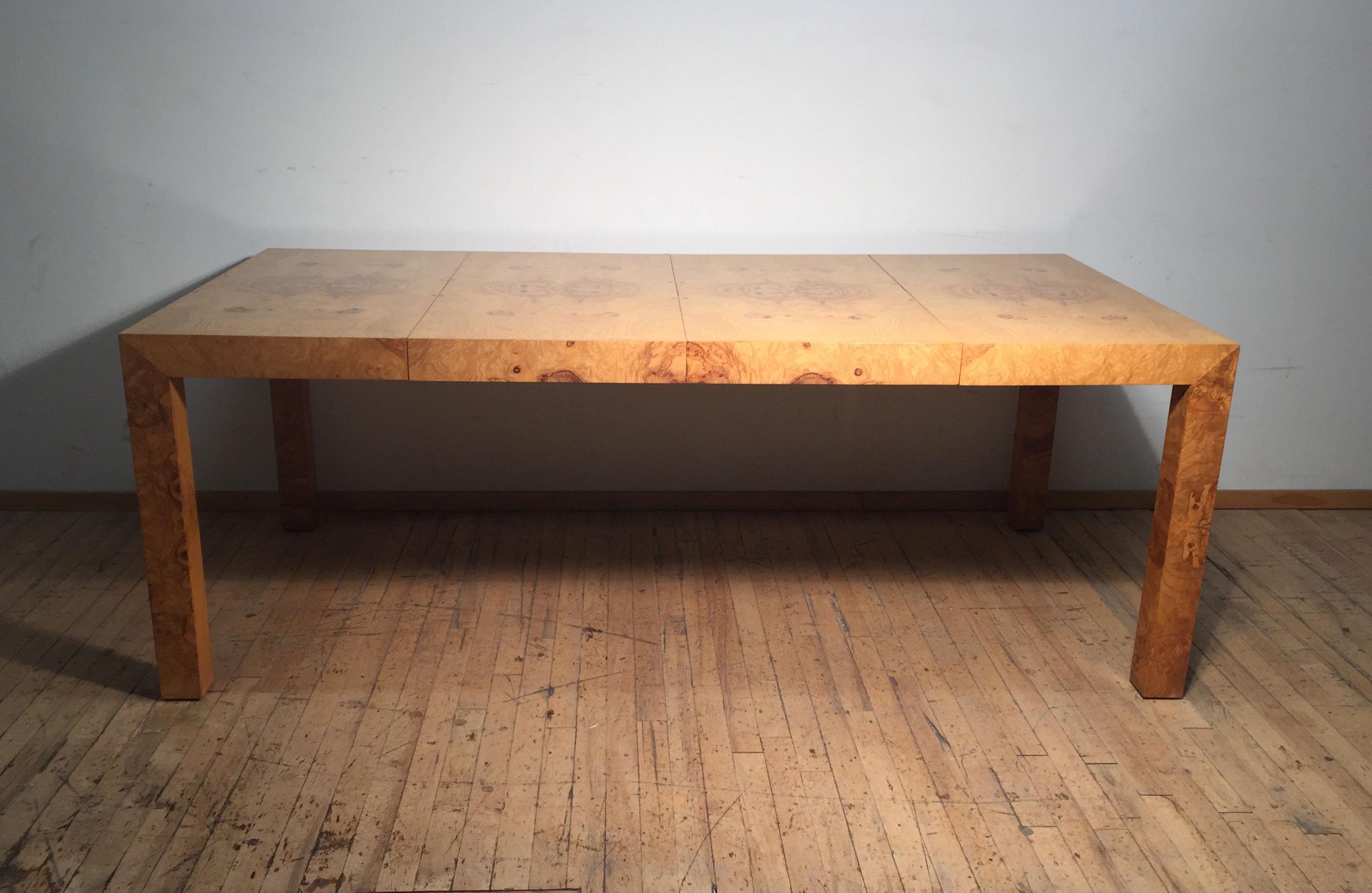 Fantastic dining table by Milo Baughman. Beautiful wood grain. Can either be a small square dinette table or functions as a longer rectangular dining table with two Leafs. Condition is all original and is in excellent vintage condition. Well