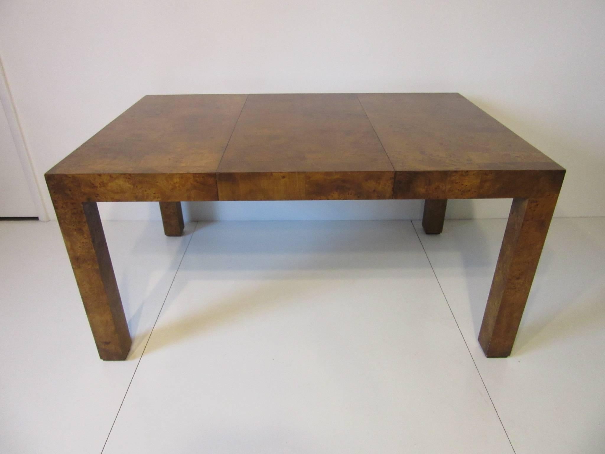 A fine darker toned burl wood Parsons dining table with two 20