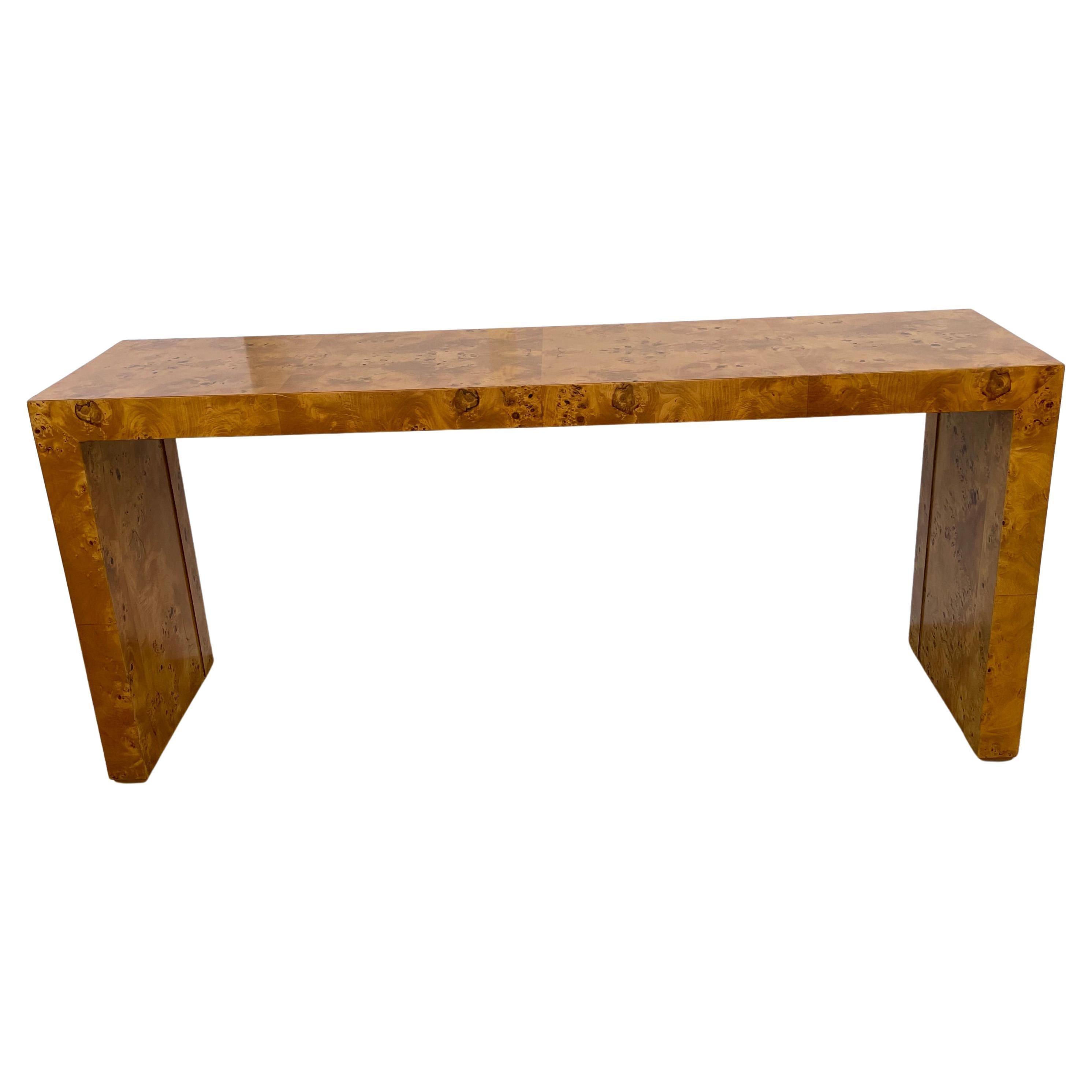 This stylish and chic burlwood console table dates to the 1970s and was created by Hekman for their Wind Row Collection. The piece has clean lines and a nice detail on the enside legs with a raised section (see images).

Note: The piece has been