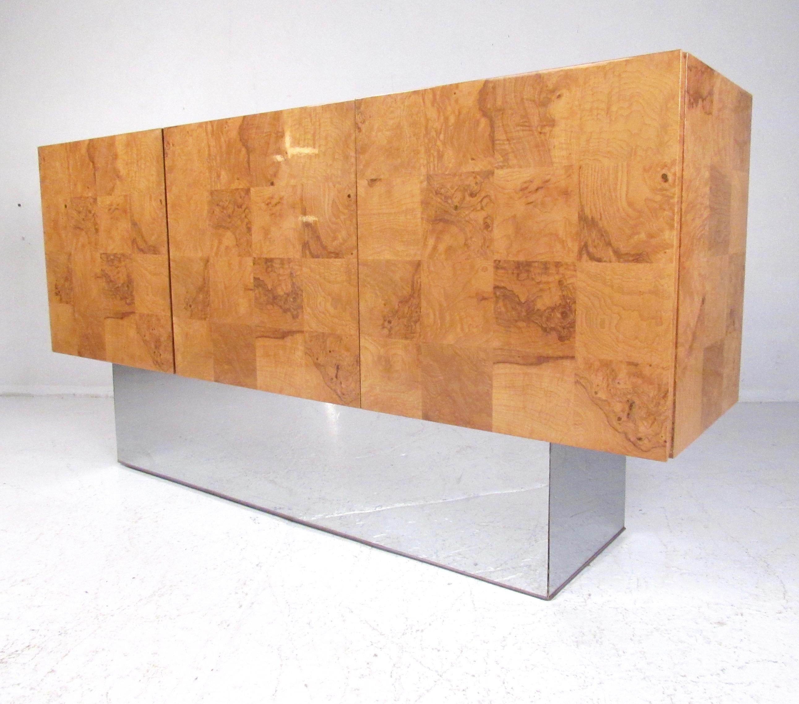 Impressive Mid-Century Modern sideboard by Milo Baughman features exquisite golden bird's eye burl wood with stylish metal  base. The spacious shelved interior also features drawer storage for silverware. Original manufacturers label intact, perfect