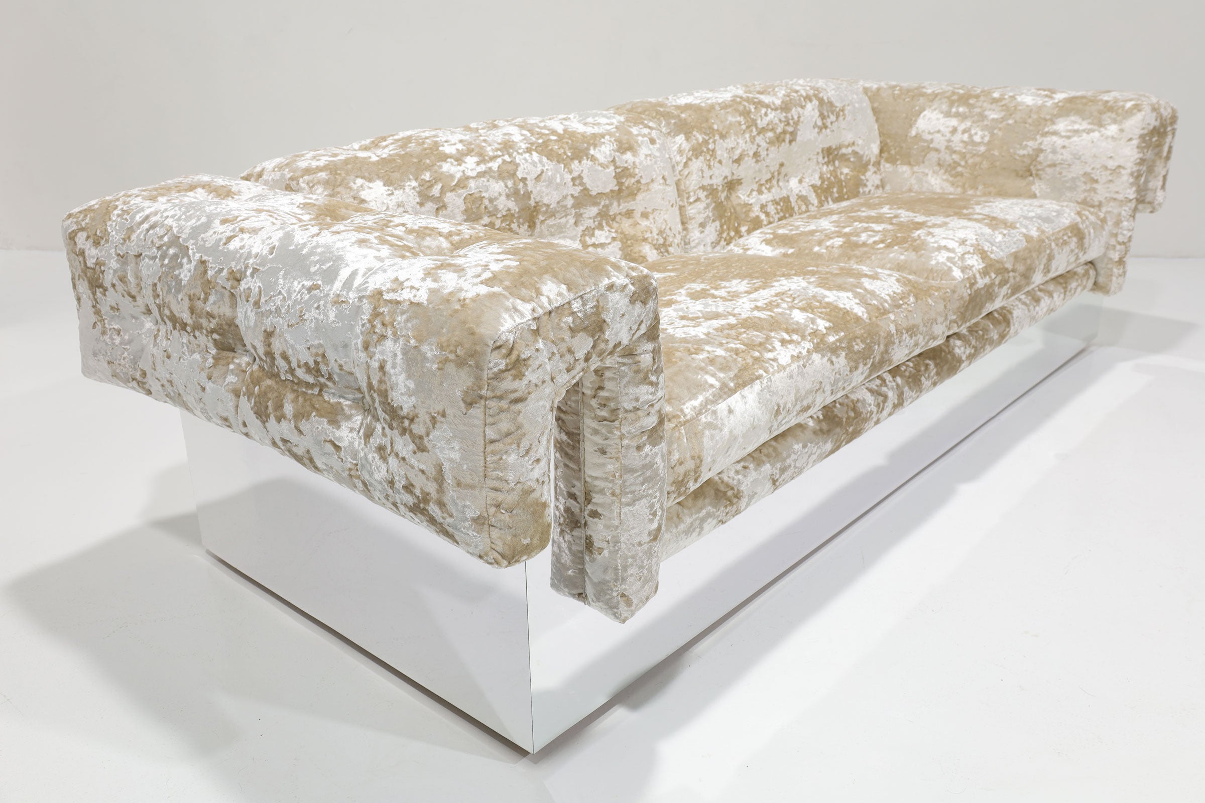 Experience one of Milo Baughman's most glamorous and comfortable sofas clad in chrome with button tufted seating and rolled arms. We specialize in high-quality mid-century modern furnishing, and this piece epitomizes our commitment to timeless